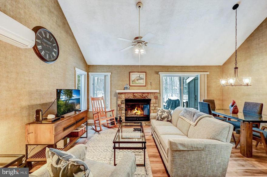 Charming Pocono end unit townhome with all the bells and whistles! Featuring granite countertops, hardwood floors on the main level, cozy fireplace, and ductless HVAC for efficient heat and air conditioning. The main floor offers a primary bedroom with an adjoining full bath, while the upper level features a spacious sleep loft with an adjoining half bath and new carpeting. Enjoy walking trails to the ski mountain, minutes to golf, and optional memberships to private Big Boulder Lake for boating, swimming, and lakeside fun. Being sold furnished for a turn-key retreat!