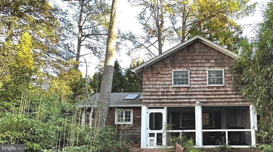 Just 1.5 blocks to Deauville Beach and Tennis Courts and nestled into a beautiful, wooded lot on one of the most desirable streets in The Pines. This classic cottage was renovated in 2023 and nothing is needed but your beach chairs and bathing suits.  Open living spaces and renovated kitchen greet you on the main level which includes a bedroom, full bath and laundry.  The upper level features a primary with direct access to the large, shared bath, two additional bedrooms, and a loft area with daybed.  The house sits on the back corner of the lot, offering both privacy and room for an additional 1500 sqft two story addition.  The Rehoboth Building Code compliant architectural plans convey and include new living/dining/kitchen addition and primary suites on 1st and 2nd levels (see attachments).  Priced at lot value this is also a great opportunity to bring your own plans and build the beach getaway you've been dreaming of.