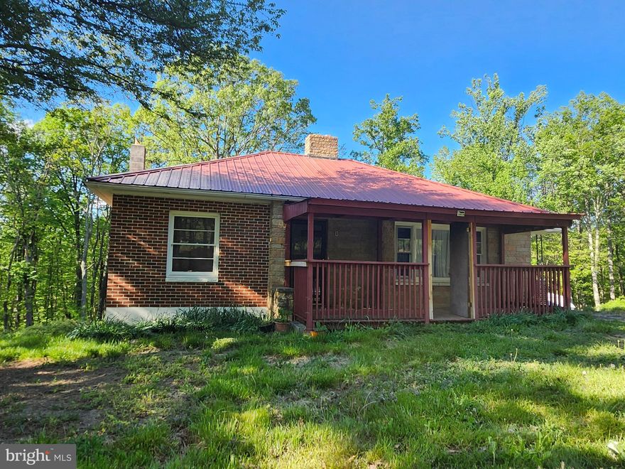 7+ unrestricted acres just minutes from the quiet town of Capon Bridge, West Virginia, is where you will find this charming brick ranch-style home.  2 bedrooms, 1 bath, full kitchen, formal dining room and huge living room with fireplace.  This home provides a sturdy foundation with immense potential.  A classic home with a traditional and efficient floor plan, arched doorways and much more. Original hardwood floors that just need your touch to bring back that rustic charm.  A full basement providing ample space for storage or expansion, this property presents an ideal canvas for customization and modernization to suit your vision or needs. Excellent opportunity for a homestead or a bustling farmstead, the generous acreage offers endless possibilities for cultivation and outdoor pursuits unencumbered by restrictions or association rules!  Covered front porch offers additional outdoor space to enjoy as well as an ample sized breezeway off the kitchen!  Small shed conveys with the property.   Conveniently located near schools, shopping amenities, and the beautiful, enjoy a blend of rural tranquility in the Hampshire County, WV countryside. Grab the opportunity to breathe new life into this timeless home.