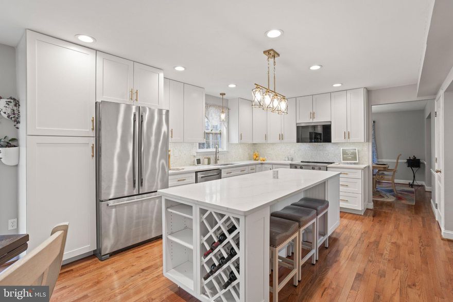 Welcome to the highly sought-after neighborhood of Victoria Station, a beautiful lake community featuring tennis and pickleball courts, a basketball court, playground, walking path, benches, and a lake for morning or evening strolls, as well as catch-and-release fishing. Welcome HOME to Victoria Station’s-1860 Battery Lane, a beautifully landscaped home with a backyard oasis perfect for entertaining and hosting celebrations of all kinds. Enjoy the large custom-built patio, firepit, water features, and landscape lighting throughout, (connected for easy access) wired to a switch. Step inside the open foyer and be captivated by the new 2025 gourmet kitchen, featuring quartz countertops, stainless steel appliances, a stunning backsplash, and elegant finishes. The oversized island offers ample space for serving, cooking, and entertaining, along with a retractable charging station built right into the quartz countertop. The kitchen also includes a beverage bar with instant-hot and filtered water access, a built-in beverage fridge, a tastefully designed indoor herb garden planters, perfect for growing your own herbs and spices year-round. The main level features a half bath, a custom office space ideal for working from home or homeschooling, a formal sitting room overlooking the wraparound, a dining room with door access to the back deck, and a spacious family room with a glass enclosed gas fireplace and custom built-ins. Upstairs, the primary suite offers a large walk-in closet spacious enough for two featuring automatic lighting as you enter and a touch lighted full length mirror. Three additional generously sized bedrooms and closets, as you continue through this spacious upstairs, and a full hall bathroom provide plenty of room for a growing family. The hall bath was customized to separate the shower area from the vanity, allowing two people to use the space at the same time. Upper-level laundry adds everyday convenience. The fully finished basement offers excellent potential for multigenerational living, featuring a living room, playroom/craft room/office, large bedroom, full bathroom, and a kitchenette serving area with access directly to the backyard patio. The basement level entry creates a private entrance opportunity to access the lower level without going through the main entrance of the home. Situated in a cul-de-sac on 1.02 acres backing to mature trees, the property also includes a beautiful fenced garden, established and ready for your homegrown vegetables and more. A 2-car garage and ample driveway parking provides plenty of room for multiple vehicles, as well as space for a trailer or boat. More upgrades to include Lawn Sprinkler System and customized to water the gardens, Gas Water Heater was replaced in 2024/25, Windows by Thompson Creek 2011, HVAC 2010, Radon Mitigation 2021, Roof 2011, Gutters & Guards 2011, Bright custom lighting throughout this home including lighting in all bedroom and foyer closets. The yard is surrounded by a Dog-Watch buried Hidden Fence (dog collar included) allowing pets free run of the property. (25.1 miles) to Joint Base Andrews, (41.4 miles) to Pax River Naval Station, (30.1 miles) to Naval Academy Annapolis, MD, (40.6 miles) to Fort Meade Main Gate, (35.7) miles to Pentagon. Located just minutes from North Beach, Chesapeake Beach, Herrington Harbour North & South, North Beach Boardwalk, and a variety of restaurants, shopping, parks and recreation. Welcome to Calvert County and all it has to offer!