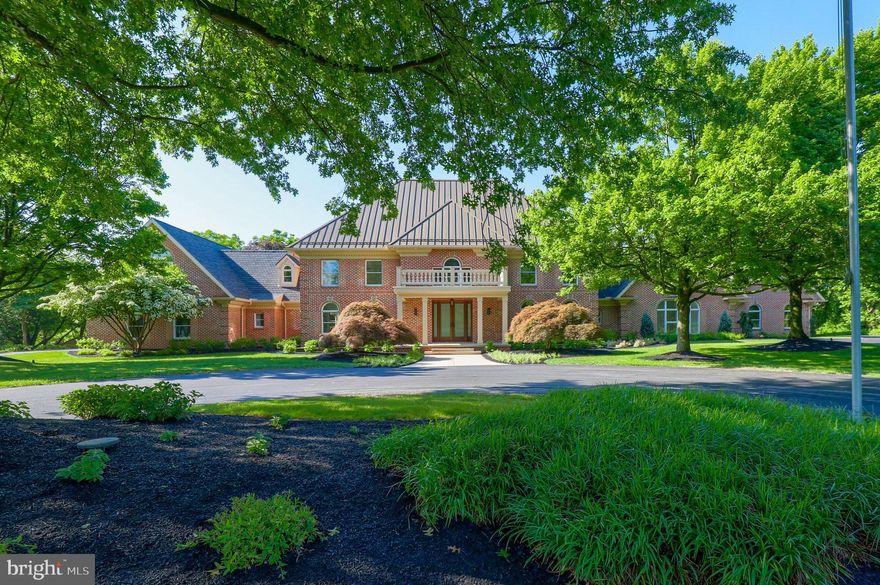 This exquisite manor in Lower Paxton Township spans across ten pristine acres unveiling a luxurious brick home boasting eight bedrooms, five full and three half baths, over 11,000 square feet, and is a must see that offers everything from elegance to warmth and fun. This gem is upgraded and modernized throughout, making it an open and inspiring move-in ready opportunity. As you pass through the new mahogany front door, you will be in awe of the new hardwood floors throughout, the soaring ceilings, detailed molding, and brand-new appliances. The grand two-story foyer is welcoming while showing off an open floor plan and providing easy access to other mesmerizing rooms, each with their own modern identity. The large foyer opens into the music room and dining room, both are complete with hardwood floors, crown molding, and large windows that let in lots of warm and natural light. The sunken family room is an excellent space for entertaining or relaxing with custom built-in shelves, gas fireplace, and easy access to the patio area. A chef's dream gourmet kitchen is simply breathtaking with two islands, custom hanging light fixtures, breakfast bar, brand new top-of-the-line Thermador appliances. There is no shortage of cabinet space and granite countertops either. In front of the large pantry closet with a barn door is a stunning butler's pantry with a built-in stainless-steel refrigerator and built-in wine fridge, ideal for pouring a glass of wine or making your favorite cocktail. The custom laundry room and mudroom are a real treat with bench seats, closets, cubbies, a convenient pet wash station with easy step up, as well as access to the attached two-car garage. Also on the main level is a large office that could double as a bedroom, den, or playroom that overlooks the pool area. A set of French doors open into a one-of-a-kind Great Room containing vaulted ceilings, exposed beams, a grand atrium window display at both ends of the room, and a gas fireplace with custom surrounding built-ins with a space for a TV. A staircase in the kitchen leads to the upper-level hosting five bedrooms, three full baths, and multiple closets including one with a laundry closet. The oversized owner's suite is spectacular with a three-tier tray ceiling, crown molding, gas fireplace, double walk-in closets, and a balcony overlooking the pool. There also is a pristine bath with dual vanities, soaking tub, rounded bay of windows, and an incredible walk-in shower with glass door and two shower heads at both ends. Each of the remaining bedrooms are spacious with plenty of closet space. Two of the rooms share a Jack & Jill bath, and the large room at the end of the hall could be used as a playroom, large nursery, or craft area that has endless possibilities. The finished lower level is an entertainer's dream with a game area and wet bar overlooking the home theater with platform for raised seating. It is the perfect place to entertain guests, business partners, host the big game, or stay home for a movie night.  Past the Great Room on the main floor there also is in-law/guest quarters with a one-car garage, full kitchen with center island, stainless steel appliances, and tile backsplash. The in-law/guest quarters has its own personal entrance into a spacious living room. It also has easy access to a covered porch, patio, and the pool area. There are two bedrooms, one full and one half bath on the main floor and a staircase that leads to a third bedroom on the second floor. There also is a laundry room with washer and dryer and a utility sink. This end of the manor is great for guests or extended family but is still accessible to the main home. The exterior of this property is just as incredible with a fenced-in patio featuring a beautiful in-ground pool, lush landscaping, a large shed, scenic pond, and circular driveway.