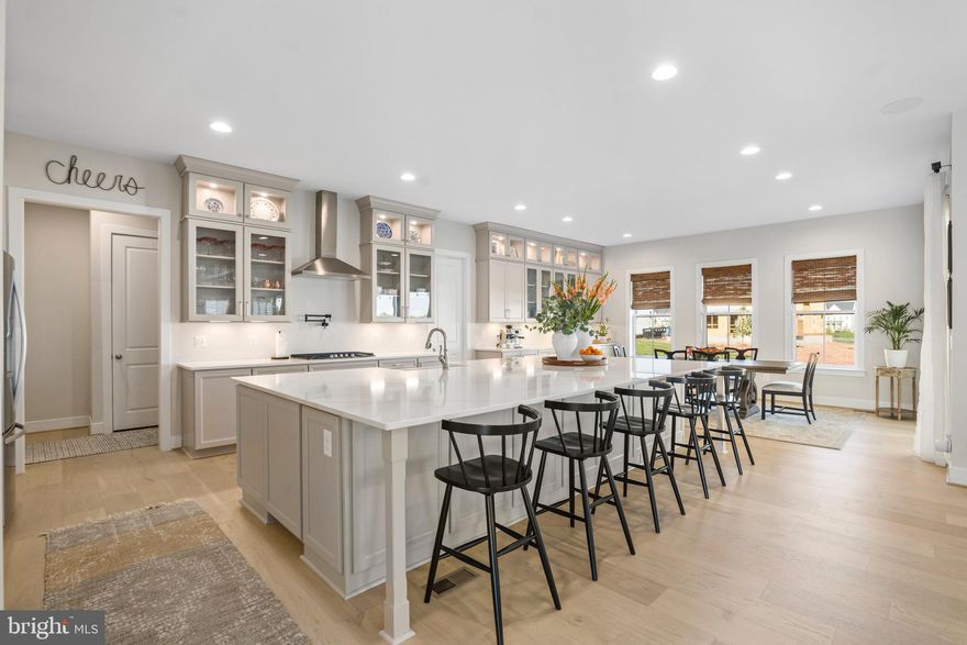 STUNNING Richmond model by Dan Ryan builders less than 1 year old in the highly sought after Hartland Community! This home offers a modern layout with classic touches including elegant coffered ceilings, convenient main level office, indoor and outdoor fireplaces, formal dining room, and open kitchen to family room design. The main level features custom huge slider panel doors, allowing for a fully open space flowing between the family room and covered porch; ideal for large gatherings! Upstairs, the primary bedroom suite features coffered ceilings, dual walk-in closets, and a private bathroom with oversized Roman shower, stand alone soaking tub, and dual vanities. Three spacious additional bedrooms complete the upper level, each with their own private bathrooms. The basement is fully finished with a large recreation room, 5th bedroom, full bathroom, exercise room, and custom wet bar with beverage station. The premier Hartland community maintains exquisite amenities, including resort style pool, fitness center, tennis courts, basketball courts, pickleball court, private clubhouse, and miles of trails and parks. Located minutes from Dulles Airport, major commuter routes, top rated schools, shopping, dining, entertainment, and more. MUST SEE! Accepting Back up Offers