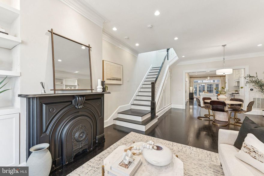 Elegantly renovated Dupont Circle rowhome on picturesque Corcoran Street, seamlessly blending historic charm with modern sophistication. Renovated in 2011, this residence offers three bedrooms, two and a half baths, plus a legal one-bedroom, one-bath lower-level apartment with a private entrance — ideal for guests or rental income.

The open main level features dark-stained hardwood floors, high ceilings with recessed lighting, and oversized front windows that flood the space with natural light. The front living area with its original fireplace mantle flows effortlessly into a spacious dining area, perfect for entertaining. The gourmet kitchen is a true showpiece, boasting a Viking range, Sub-Zero refrigerator, marble counters and backsplash, custom cabinetry, pendant lighting, and a large breakfast bar. A cozy rear living area opens through French doors to a private flagstone patio shaded by crape myrtles, with convenient off-street parking just beyond. There's also a stylish powder room on the main level that's ideal for guests and entertaining.

Upstairs, the expansive primary suite includes a walk-in closet, hidden storage, and a luxurious ensuite bath with a marble double vanity, soaking tub, and separate glass shower. Two additional bedrooms, a second full bath, and washer & dryer complete the upper level.

With its own Certificate of Occupancy, the lower level unit features a full kitchen, spacious living area, washer and dryer, and separate HVAC system. It will also convey vacant, so the possibilities are endless! Ideally situated just seconds from popular 17th St restaurants and shops, Safeway & Whole Foods, dog parks, and Metro, this stunning home offers timeless style and exceptional convenience in one of D.C.’s most desirable neighborhoods.