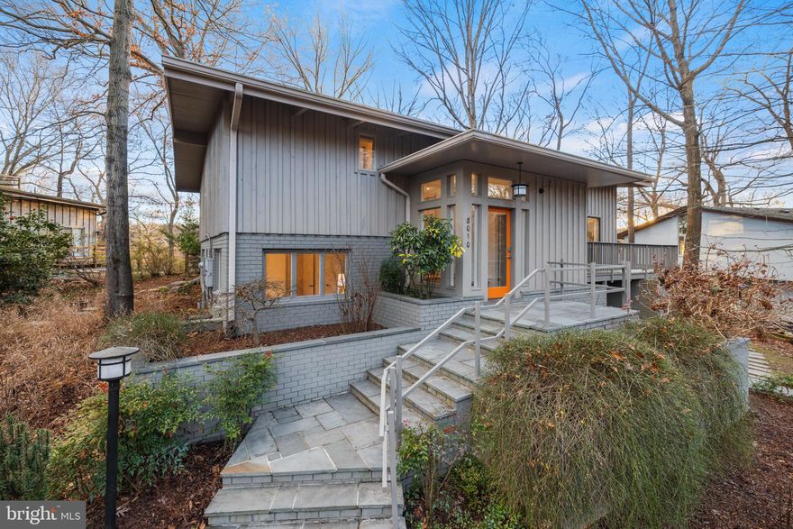 Welcome to 8010 Riverside Drive, a beautifully updated, mid-century modern home nestled in the tree tops with stunning views of the Potomac River and the C & O Canal. Boasting gorgeous hardwood floors, vaulted ceilings, extra large windows, amazing natural light, an abundance of storage, and a huge wrap-around deck, this home is sure to delight! Upon entering the property, the welcoming foyer features slate floors and a large walk-in closet. As you walk down the main hallway, you'll notice the beautiful built-ins with a natural wood-finish that line the entire left side wall, perfect for displaying all of your treasures. The expansive living room features vaulted ceilings, exposed wood beams, large windows for an abundance of natural light, and a cozy fireplace, and is open to the dining room all with direct access to the massive wrap-around deck that was built around a tree and features breathtaking views of the Potomac River. The perfectly appointed kitchen is open to the dining room and has stainless steel appliances, including a gas cooktop and wall oven, as well as a beverage fridge, sleek flat-front wood cabinets and granite countertops. The main level also includes a office/bedroom/flex space with direct access to the wrap-around pressure-treated deck! The primary suite has mini-double door entry for additional privacy. The primary suite is a true owner's retreat, and features skylights, a large walk-in closet with custom built-in closet organizer, and a washer and dryer, plus an en-suite bath with dual sinks and large shower. Making your way to the lower level, which features new engineered hardwood floors and a spacious family room with a 2nd fireplace and direct access to the walk-out and partially covered flagstone patio and your little personal pond. An added bonus are the many storage areas that are located along the perimeter of the home, which are more than enough to house all of your outdoor toys and gardening tools. Completing the basement level is a bedroom and full bathroom with ample closet space, and a large storage / laundry room. As much as there is to love inside the home, there's even more to love nearby! EXCELLENT LOCATION! Situated overlooking the Potomac River, you're just moments from the Chesapeake & Ohio Canal Trail, perfect for all of your leisure needs, and minutes to Cabin John Local Park and Glen Echo Park, and just a bit further to Congressional Country Club and Burning Tree Club. For your everyday needs, you're a quick 5-minute stroll (2 blocks) to MacArthur Plaza, which features the Bethesda Co-Op, Salon Jean & Day Spa, a post office, and great eats such as Fish Taco Mexican Taqueria, Sal's Italian Kitchen, and Wild Tomato Restaurant and Bar. Minutes to Bethesda and just a bit further to DC and Tysons for premium shopping, dining and entertainment. Nearby to major employers (Amazon, Gannett, Capital One, Freddie Mac, Northrop Grumman, Federal Government, to name a few) and hospitals (Suburban Hospital and Walter Reed Medical Center). Nearby to major commuter routes (I-495, Clara Barton Parkway, George Washington Memorial Parkway, and River Road) and less than a quarter mile to the bus stop. Bannockman Elementary, Thomas W. Pyle Middle, and Walt Whitman High School Pyramids. Don't miss this ONCE IN A LIFETIME opportunity to own this most singular property overlooking the C & O Canal with PRIME views of the Potomac River! A true nature lover's retreat yet nearby to the best of city living. This Is It! Welcome Home!