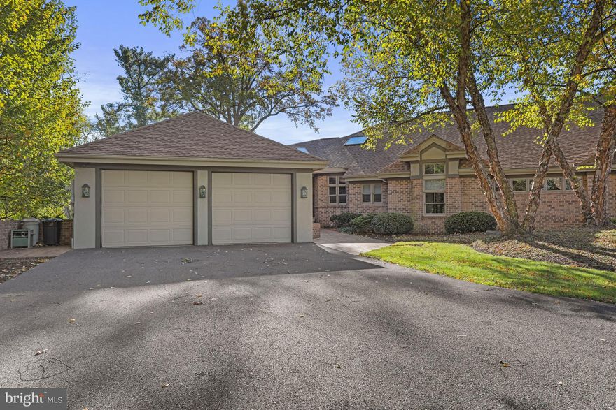 This beautiful, custom built, mid-century modern, half duplex, located on the 9th green of the Chambersburg Country Club, in Scot Greene Estates, is just what you've been looking for!!  Designed by two friends, an architect and an engineer, this home boasts a stunning blend of brick and stucco exterior and provides over 6000 square feet of finished living space, 4 bedrooms and 3.5 baths! As you arrive, the winding shared driveway and beautiful mature landscaping welcomes you, providing ample parking. A charming brick walkway leads you to the front entrance. As you step inside, you will be greeted by a spacious two-story foyer with beautiful red oak hardwood floors and skylights that flood the space with natural light! The open kitchen is a chef's dream, featuring hardwood floors, additional skylights,  a large island with cooktop and stainless steel appliances. There is even a wine fridge! The kitchen also features under-counter lighting, a double sink, beautiful glass tile backsplash, a vegetable sink, a built-in breakfast table and a walk-out to the rear balcony, complete with an awning and propane hook up for outdoor dining! Oh, lets not forget the large walk-in pantry for tons of storage! Adjacent to the kitchen is the formal dining room adorned with those beautiful red oak floors and a double sided gas stone fireplace, which creates both warmth and ambiance. The spacious living room on the opposite of the fireplace, is equally impressive, with cathedral ceilings,  red oak hardwood floors, a large window and built-in media center, complete with surround sound, making it an ideal space for entertaining.  A dedicated office space, offers built-in desks, cabinets, file drawers, and privacy enhancing French doors, for a quiet and functional workspace. The primary bedroom, located on the main level, is a luxurious retreat with cathedral ceilings, a cozy fireplace and lots of built-ins, including dressers and an entertainment center. The en-suite bathroom features tiled floors, a dressing/vanity area, private toilet area, walk-in shower, jetted tub, cathedral ceilings, walk-in closet, and ample linen storage. The main level also includes a second bedroom, with cathedral ceilings and conveniently connects to the laundry room. The main level laundry room  features those beautiful red oak hardwood floors, a utility sink and a built-in ironing board.  A powder room and an enclosed rear porch, with brick floors walking out to the rear terrace, add to the home's charm and round out the main level. On the upper level, you'll find a versatile loft space with built-in bookcases, perfect for a home office, or a reading nook.   The walk out, finished lower level is impressive with it's spacious family room,  and two additional bedrooms, both with private baths! Your guests will never want to leave! The family room walks out to a covered rear porch, with an additional propane hook-up for a grill, providing a peaceful outdoor retreat, or entertaining area. The lower level also houses a large storage room, complete with a utility sink. Additional features of this home include a two car attached garage for additional storage and secure parking, an 80 gallon hot water heater,  a new roof in 2023, new exterior paint in 2021, 2x6 framing and Anderson 3E glas windows. With so many luxurious amenities, this property offers a blend of modern living and timeless elegance, all in the serene setting of Scot Greene Estates! This home is just a stroll away from the Chambersburg Country Club, being the closest home to the club and the first hole golf tee! Perfect for the avid golfer! The Club is proud of its championship 18-hole golf course, versatile 25,000 square foot clubhouse, and wonderful pool and tennis facilities. Located less than a mile from interstate 81 and within an hour's drive to Harrisburg, Carlisle, Hagerstown & Frederick this is an ideal location.  Don't miss out on this rare opportunity! Room sizes and square footage are estimated.