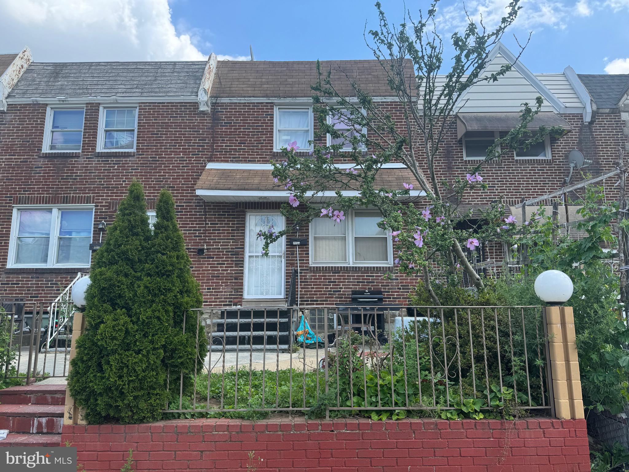 Charming row home located in the highly desirable Castor Gardens neighborhood. This classic-style residence features a welcoming front patio, a walkout basement in the rear, and the added convenience of off-street parking. Enjoy excellent walkability, easy access to public transportation, and proximity to major roadways—making commuting a breeze whether by foot, transit, or car. You are nearby supermarkets, local favorites, stores restaurants and more so you can enjoy the neighborhood and experience everything the city of Philadelphia has to offer. Can be sold as a package with home next door (7155). Property is sold asis and seller will not make repairs. Seller will provide U&O.