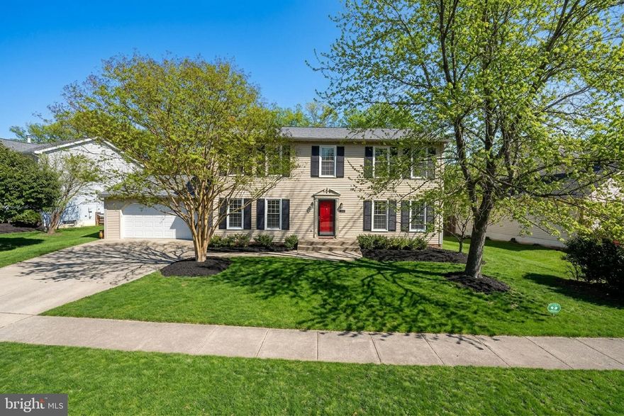 Welcome to 21112 Midday Lane in Sterling, Virginia, a beautifully remodeled colonial tucked into the sought-after Cabin Branch Forest community.  This home has been lovingly updated and carefully maintained. With 5 bedrooms, 3.5 bathrooms, and over 3,100 finished square feet, there’s plenty of room here to spread out, entertain, and truly feel at home.

Step inside and you’re greeted by warm hardwood floors, crown molding, and freshly painted walls that create a bright and welcoming atmosphere. The main level flows effortlessly from the formal living room and elegant dining room into a spacious open-concept kitchen and family room—perfect for everyday living and hosting.. The family room centers around a wood-burning fireplace, making it the ideal place to relax on cool evenings.  The  fully remodeled kitchen shines with granite countertops, white shaker cabinets with soft-close doors, stainless steel appliances, and a sunny breakfast area.

French doors open to a Trex deck overlooking a large, flat, tree-lined backyard, creating a peaceful outdoor retreat that’s perfect for grilling, gatherings, or simply unwinding after a long day. The main level also features a flexible 5th bedroom, ideal for guests, a home office, or multi-generational living.

Upstairs, you’ll find four spacious bedrooms, including a relaxing primary suite designed for comfort. The suite offers two closets, including a walk-in, and a beautifully remodeled spa-inspired bathroom with double vanities, soft-close drawers, and a luxurious shower. A remodeled hall bathroom and convenient linen storage complete the upper level.

The fully finished lower level expands your living space even more with a large open recreation room that easily accommodates a lounge area, play space, home gym, or office setup. This level also includes a full bathroom, dedicated laundry room with washer and dryer, and additional storage space.

Beyond the beautiful finishes, the home has been thoughtfully updated with major improvements, including a new roof (2021), Trex deck (2020), Bosch HVAC system with smart thermostat (2024), new 75 gallon water heater (2025), updated driveway and walkway (2023), new garage door (2025), and refreshed lighting, new carpet, and primary bath in 2026. An attached two-car garage and quality double-hung windows add even more convenience.

Situated on a flat quarter-acre lot, this home offers the perfect mix of privacy, space, and neighborhood charm while still being close to shopping, dining, commuter routes, and everything Sterling has to offer.

Homes this updated and move-in ready in Cabin Branch Forest don’t come along often. Come experience 21112 Midday Lane for yourself and see why this could be the perfect place to call home. Schedule your private tour as soon as possible before someone else falls in love with it first.