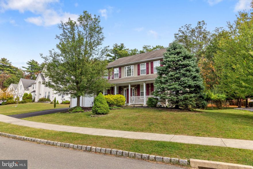 Beautiful 4 BR, 2.5 BA 2-story center hall Colonial in Blue Mountain Lake. The welcoming front porch leads to a 2-story entry Foyer with hardwood floors. Formal Living room with wall-to-wall carpet, crown molding. Formal Dining room with wall-to-wall carpet, chair rail & crown molding & pass thru to Kitchen with bar area with built-in cabinetry. The large Kitchen offers upgraded countertops, large island with breakfast bar seating for 2, oak cabinetry, gas range, built-in microwave & wall oven. Breakfast area with additional cabinetry & secretaries desk & sliding glass door leading to large deck & brick patio with retaining wall overlooking the private, wooded rear yard. Half wall from the Breakfast area to the Family room with gas fireplace. Hallway from Kitchen leads to first floor powder room, laundry room & access to 2-cr Garage. Oak stairs in Foyer leads to the 2nd floor landing. Double door entry into the Primary BR offering wall-to-wall carpet, tray ceiling, 2 walk-in closets, dressing/sitting room & full Primary Bath with corner soaking tub. separate  walk-in shower & double vanity. Three additional large bedrooms all offer wall-to-wall carpet & double closets. Full hall bath with double vanity & tub/shower combination. Full, unfinished Basement.