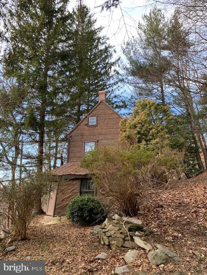 Charming and very much unique 18th century home nestled on the east side of South Mountain, western Frederick County, in need of a new owner. This private little bit of heaven, one bedroom/one bathroom home, is a diamond that with some polishing will provide much enjoyment. Both, private and close to surrounding historic sites, the property offers original chestnut floors and beams, waiting to be brought back to the original gleam, and two and half acres of beautiful indigenous and exotic trees and shrubs. The spartan full bathroom with a bath tub carved out of rock, and the lower level kitchen with the old wood stove, are just part of the charming features the property has to offer. Not recent, but updated electrical wiring, furnace, roof and plumbing. Must see to appreciate the charm and what the features the property offers. Measurements are approximate. 
This is not a drive by! Must schedule with the listing agent to see it.