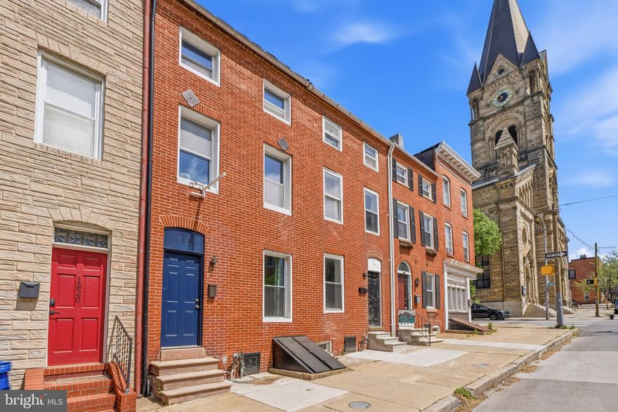 Situated a few blocks west of Patterson Park and north of Fells Point, this home is conveniently located with easy walkability.  We took time off to make big improvements to the home some of which are entire home was freshly painted, new carpeting was added, and new Kitchen installed.  Kitchen has new navy blue & white Shaker cabinetry and new Quartz countertops. There is a Pantry and table space as well.  Main level entry leads to hardwood flooring in the Living Room and Dining Room.  There is a Laundry area and Powder room also. Upper Level has a full bathroom, 2nd and 3rd Bedroom with new carpeting.  Stairs on that level lead to 3rd story with the Primary Bedroom and Bonus room which also has new carpeting.  Bonus room can be used in multiple ways including Dressing Room, Office, Fitness Room, Family room, or 4th Bedroom. This level is flexible and can be imagined and used as needed. The door leading from the Kitchen takes you to the covered screened porch that with some sweat equity can be made into a great outdoor space.  There is a backyard, gardens, and gate to walkable alley too which is great for city living. There is a Basement/Cellar accessed from front which has tall ceilings and is rather large which can be used for storage too. 
Prime location, flexible floorpan, great improvements, generous outdoor space.....Make this yours!