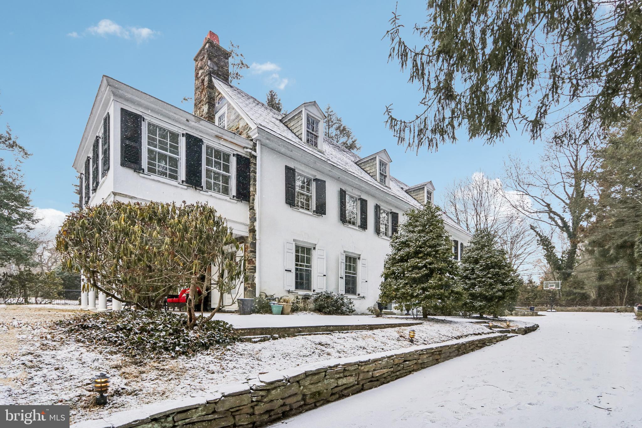 Welcome to 311 Kent Road, a classic center hall colonial nestled within one of the most walkable and most cherished family neighborhoods in the Main Line. Wide, tree lined streets with sidewalks and beautiful historic homes encourage a leisurely stroll to Ardmore's Suburban Square, Narberth's Town Center, and the Wynnewood Shopping Center. Enjoy close proximity to Trader Joe's, the Ardmore Farmer's Market, Whole Foods, many restaurants, brewpubs, interesting shops, the Narberth library and playground, and Lower Merion High School and its athletic fields, track, and tennis courts. Rail commuters can walk to SEPTA's Wynnewood station in just seven minutes. The Ardmore station is also only minutes away and has access to AMTRAK to New York City. This special 6 bedroom, 4 1/2 bath home in the Toland Farm Neighborhood is situated on a level lot that backs to a preservation meadow for additional privacy. There are many authentic elements, including hardwood floors, built-ins, interesting millwork, original hardware, arched doorways, and multiple fireplaces, that epitomize Main Line architectural charm. This home also accommodates the needs of today's lifestyle with its renovated kitchen and family room addition. Drive through the wrought iron gate at the front of the property and down the private driveway to the slate steps that lead to the main entrance. Enter into the stately center hall which features hardwood floors, framed archways, crown molding, wall sconces, and double French doors that open to a flagstone terrace with stone sitting wall. To the left of the hall, is a gracious living room that boasts built-in shelves, crown molding, a wood burning fireplace with marble surround, and a Dutch door out to a large covered patio. This patio is the perfect place to enjoy your morning cup of coffee or just watch the world go by. To the right of the center hall is a formal dining room that can seat a large group comfortably and hosts two built-in china cupboards, wall sconces, a decorative fireplace, and hardwood floors. A side hallway off of the center hall includes an under staircase closet and a powder room with a pedestal sink, and leads to the original butler's pantry and back stairs to the second floor. The butler's pantry with its ample cabinetry and sink serves as the beverage center when entertaining. The renovated kitchen is equipped with attractive wood cabinetry, granite countertops, ceramic tile backsplash and floor, stainless steel appliances, including a one year old refrigerator, double oven, gas cooktop, microwave oven, and dishwasher, a separate desk area, and a cozy breakfast bar. The kitchen opens to a sun drenched family room that was thoughtfully added to enhance the home's flow and is rarely found in older homes. The family room showcases a vaulted ceiling with skylights, a gas fireplace, and French doors out to the flagstone patio where you can enjoy al fresco summer dinners. The adjacent mud room houses a laundry closet with full size washer and dryer, a large coat closet, bench seating, and an exit to the driveway and 2 car detached garage. The basement provides plenty of storage possibilities and has a covered outside exit to the side yard. The turned staircase to the second floor leads to the owners' suite which is comprised of a spacious bedroom with a fireplace and Dutch doors to a private bright sitting room, and a full bathroom that connects with bedroom 2 which features a stained glass transom and sconces. The second floor offers 3 additional bedrooms that share 2 full hall bathrooms. You will have plenty of space for family and friends. The third floor includes a generously sized bedroom with a ceiling fan, a renovated hall bathroom with walk in stall shower and vanity, 2 storage rooms, and a cedar closet. Don't miss out on the rare opportunity to live in a prized location within the award winning Lower Merion School District. So schedule your appointment today.