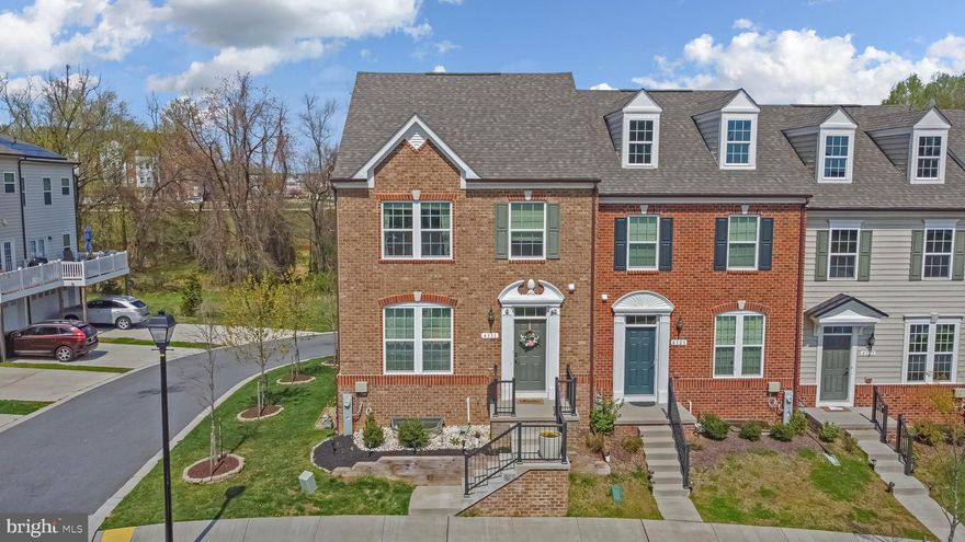 Beautiful 4 bedroom, 3 full bath, 1 half bath brick front townhome nested in the Ballard Green Community. With 2,350 sf of total space this 2-car garage fully remodeled end unit welcomes you to a main level entry with 5” ex-presso hardwood plank flooring, and an open concept living area that oversees the Kitchen & Dining room. Gourmet Kitchen features Granite Countertops, stainless steel GE Appliances, French door refrigerator, Oven & Microwave with Chef Connect (Wi-Fi capability), recessed lighting and pendant lights over 8’ breakfast island. Dining room walks out to a long deck with views of the wooded area. Lower Level includes additional bedroom with full bath, and gar-age access. Upper level showcases the Master Suite with tray ceiling, ceiling fan, spacious walk-in closet, and master bath with dual vanity, standing shower, and soaking tub. Two generous size bedrooms with lots of natural light, laundry room, and hallway bath are also found. Adjacent to Lyons Mill Elementary School. Amenities include a pool, a community center with gym, a tot lot, and picnic area. Convenient to 795 & Metro. Nearby shopping incl. Costco, BJ's, & Wegmans. Offers due by Monday, April 26th  noon.