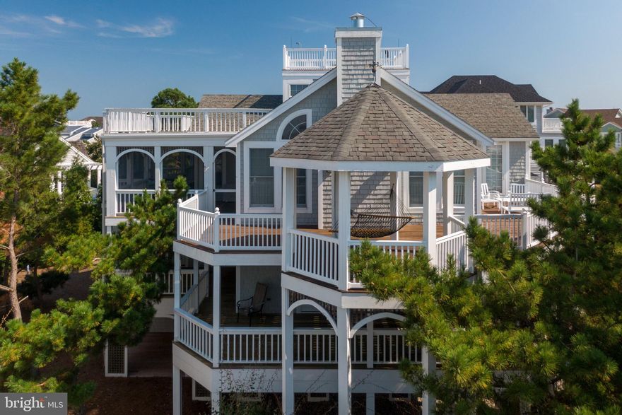 Classic beach home with ocean views. Located on a cut-de-sac in the private gated community of Pelican's Pouch and just steps from the private guarded beach. Designed for multiple families to gather and enjoy the sun, sand, and surf. This spacious home has plenty of room to spread out inside and out on multiple levels and features elevator for easy access to all floors. The home features 5 bedrooms plus a den that could be a 6th bedroom. The great room features a cathedral ceiling, lots of windows, and a wood burning fireplace. The outside features large front and rear decks with direct access to all bedrooms. There is also a large screened porch for summer meals and entertaining. To top things off there is a widows watch with scenic 360 degree views. For energy efficiency the home has been improved with geo-thermal HVAC systems. There are 2 outdoor showers, several large storage closets and lots of off street parking. Schedule your private showing today and start making your beach own memories.