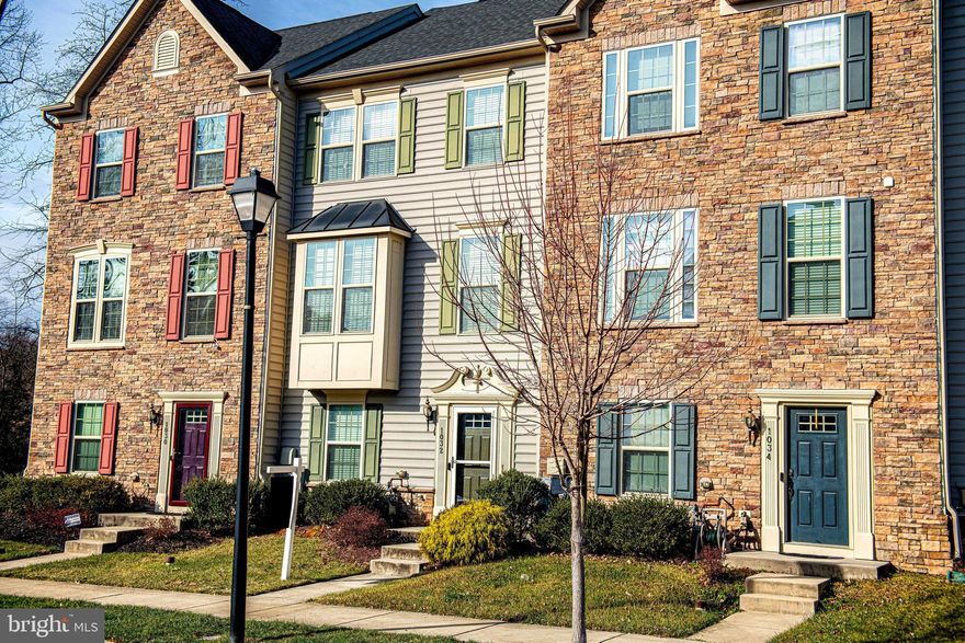 Welcome to 1032 Ramble Run Road in The Preserve at Windlass Run!  Built in 2015, this move-in-ready townhome offers 3 bedrooms, 3.5 bathrooms, plus a flexible fourth-floor loft with a full bath and private balcony—perfect for guests, a home gym, or additional living space.  The entry level features a dedicated home office with French doors and access to the rear-loading two-car garage. The main level showcases hardwood floors throughout the family room and kitchen, 9-foot ceilings, crown molding, and a bright bay window, creating an open and inviting atmosphere. The kitchen is equipped with granite countertops and stainless-steel appliances, including a new microwave and range (2025) and dishwasher (2022). Just off the kitchen, enjoy a low-maintenance deck ideal for indoor-outdoor living.  Upstairs, the primary suite features a walk-in closet and private bath with dual Roman showers. Two additional bedrooms, a hall bath with tub, and convenient third-floor laundry (LG front-load washer & dryer, 2018) complete this level.  The fourth-floor loft provides additional living space and access to the private balcony, perfect for relaxing or entertaining.  Recent improvements include: upstairs HVAC (2024, 10-year warranty), storm door (2025), fresh neutral paint (2025), and new stainless-steel microwave and range (2025).  Enjoy community amenities including a pool, fitness center, clubhouse, and playground. Conveniently located with easy access to I-95, shopping, dining, parks, and Pine Valley Swim & Tennis Club, and zoned for Vincent Farm Elementary School.  Schedule your tour today!