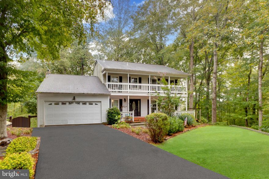 Private, wooded lot at end of cul-de-sac backing to the Occoquan Reservoir!  Multiple outdoor living spaces include a heated inground swimming pool, screened-in ground-level patio off the basement, multi-tier wood deck with access from both the family room and the main-level bedroom suite.  Steps lead down the hill through the woods to the private dock on the water, with approx. 250' of frontage on the Occoquan Reservoir!  This charming colonial offers hardwood floors on the main and upper levels, ceramic tile bathrooms, plus an upgraded kitchen with granite counters and breakfast bar.  Step down to the family room and enjoy the propane fireplace, treed views through every window, and ceramic tile flooring; perfect for handling the dripping water from swimmers coming inside from the pool!  (Swimming pool last used two years ago and was professionally closed.)  A main-level addition with full bathroom and kitchenette off the dining room can be used as a main level bedroom suite or a spacious home office with gorgeous views of the forest through windows on three sides!  Upstairs, you'll find three bedrooms with wood floors and two full bathrooms with ceramic tile floors, with the Primary Bedroom opening to a balcony overlooking the front yard.  The Mockingbird Ridge community is a beautiful, wooded enclave between Manassas and Woodbridge, with easy access in both directions via Davis Ford Rd and Prince William Pkwy, or take Yates Ford Rd north across the bridge into Fairfax County and Clifton.  Home needs refreshing to restore its former glory but the location, view, water access, and outdoor living spaces are amazing!