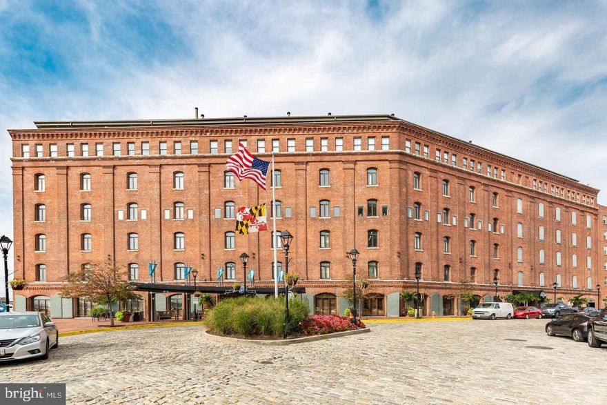 This renovated two story condominium is located in the premiere full service building of Henderson's Wharf Condominium. Natural light streams in through the garden facing windows and doors that overlook the tranquil, leafy courtyard 5 floors below. The open floor plan of the main level includes a light & bright living/dining area that is open to the beautifully updated kitchen with granite counters, tile flooring, stainless steel appliances, a large breakfast bar, and upgraded cabinetry. The bedroom level boasts a spacious bedroom with room for an at-home office space, a large closet, a convenient laundry closet, and a well designed updated bathroom with plenty of storage and a custom built shower. You'll love the ease, comfort & peace of mind that comes with living in a secure, full-service building that includes 24 hour front desk & concierge, fitness center, and secure deeded garage parking. Additional building features include a spacious lobby, beautiful garden courtyard, and an outdoor waterfront lounge area to enjoy. This historic building sits on the waterfront promenade and is nestled at the end of a cobblestone street in the perfect location that offers the best of both worlds- so close to the amenities of Fells Point, but in a quiet spot that is not on top of all the action. Life in this historic waterfront community offers so many amenities: top-class restaurants, nightlife & entertainment, charming cafes, shops, and art galleries, and a seasonal Saturday farmer's market. Plus it's an easy walk along the waterfront promenade to the nearby neighborhoods of Harbor East, Little Italy, and Canton.