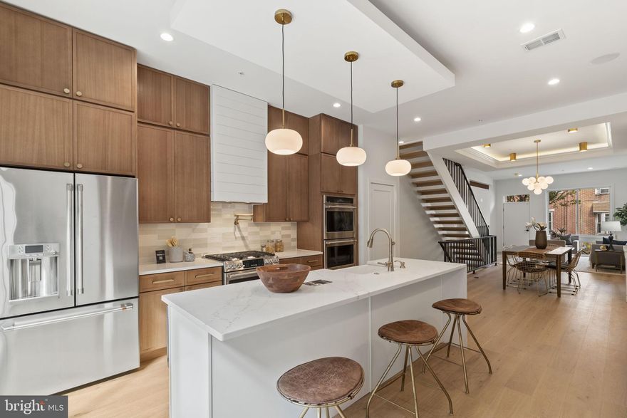 Introducing 22Fourteen Gordon a massive 4Bd | 4Ba  NEW CONSTRUCTION residence in the heart of Fishtown, next to Konrad Square Park. This stunning home combines thoughtful design, high-end finishes, and modern amenities for an elevated urban lifestyle and comes with THREE OUTDOOR SPACES. The main level features a bright, open-concept living, dining, and kitchen area with 10-foot ceilings, wide-plank flooring, and natural light throughout. The chef’s kitchen is outfitted with modern cabinetry, quartz countertops, ceramic tile accents, and a GE Café appliance package, including a Sharp microwave drawer, wall ovens, and a sleek center island. The living space opens directly to a private fenced backyard, ideal for entertaining or relaxing outdoors. The second level offers two spacious bedrooms, one with an en-suite bath, plus a full hall bath and a laundry room with side-by-side washer and dryer. The primary suite occupies the entire third floor and includes a private balcony, make-up area, and a luxury spa-style bathroom with a soaking tub, frameless glass shower, heated towel rack, and hand-selected tile finishes. A custom wet bar leads to the expansive rooftop deck with panoramic skyline views and wired speakers, perfect for entertaining. The finished basement provides a fourth bedroom, office |media room, and full bath, offering flexible living options. Additional features include high-efficiency DUAL HVAC systems, smart home technology (e-locks, video intercom, Bluetooth surround sound, security cameras), a dog wash bathroom, large yard, and full rooftop deck. Enjoy a premier Fishtown location steps from Konrad Square Park and within walking distance to LMNO, Mulherin’s, Kalaya, Suraya, La Colombe, Frankford Hall, and ReAnimator Coffee. Convenient access to SEPTA’s Market-Frankford Line and I-95 provides easy commutes to Center City, University City, and beyond. 10-Year TAX ABATEMENT in place.  22Fourteen Gordon where modern design meets Fishtown living.