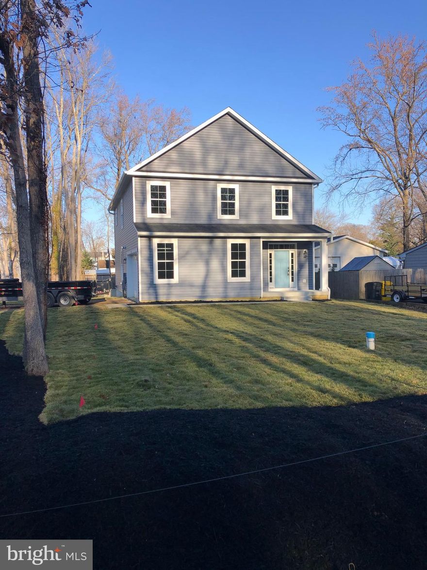 Another quality built new construction home by Jim Robinson/Real Estate General, LLC in the highly desired water privileged community of Loch Haven Beach. Ready to Move In! 4 bedrooms, 2.5 bathrooms, with a side entry 2 car garage on a level corner lot. This beautiful home is filled with natural light and features an open floor plan on the main level with wide-plank LVP flooring, 9 foot ceilings, stunning kitchen with quartz countertops, designer white cabinets, stainless steel appliances and a large center island with seating. There is also a dining  area adjacent to the kitchen and a spacious family room with a propane fireplace framed by stylish shiplap. The upper level has a luxurious primary suite with a walk in closet featuring built-ins and a spa-like bathroom  with a double vanity, and a glass-enclosed tile shower. There are three additional ample sized bedrooms, another full bathroom and a conveniently located laundry room on the second floor. Home includes an approximately 1000 square feet unfinished basement with rough in plumbing for a bathroom and steps to the outside. Community amenities include a sandy beach with chairs and picnic tables, a pier with boat slips, a boat ramp, and kayak storage racks,  an overlook on the South River, a ball field,  a recreation area with a tennis court, basketball court, and a playground with picnic tables. There are numerous community events that happen throughout the year.  Property is close to shopping, restaurants, downtown Annapolis and major roads with an easy commute to Washington, D.C.,  Baltimore and Northern Virginia. Enjoy the vacation lifestyle of this vibrant community!