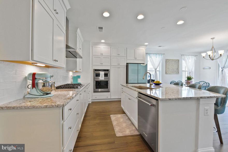 Welcome to this sun-drenched Aspen II model, offering the perfect blend of luxury and convenience with 2 bedrooms, an office, 2 full bathrooms, and a spacious 2-car garage—all designed for true single-level living. You’ll immediately appreciate over $74,000 in upgrades, including a dream kitchen (Shea's Signature model) featuring an expansive granite island, elegant white cabinetry that extends to the ceiling, and upgraded KitchenAid stainless steel appliances, including a sleek range hood and large pantry. The modern Samsung Bespoke refrigerator with a flex drawer completes the high-end kitchen experience.  Panels on the Bespoke refrigerator can be changed to different colors for those desiring a more traditional look.

The open-concept design seamlessly connects the living room, dining room, and conversation nook, allowing for easy entertaining and a natural flow between spaces. The 9-foot ceilings and abundant windows fill the home with natural light, creating an airy and bright atmosphere. In winter, gather around the gas fireplace with its stunning wood and marble hearth, while in summer, open the extra-tall sliding doors to enjoy your own covered patio with a lighted ceiling fan, perfect for relaxing with a cold drink or entertaining.
The spacious owner’s suite is an inviting retreat, with its 9-foot ceilings, large tiled shower, dual sinks on white vanities, and a generous walk-in closet. 

Throughout the common areas, rich brown engineered hardwoods create a cohesive, sophisticated look, while plush neutral carpeting enhances the comfort of both bedrooms. The laundry room is a highlight, complete with a sink, matching washer and dryer, ample cabinet and counter space, and a built-in trash bin—making everyday chores feel effortless.

Comfort is key with central air and a smart thermostat, while smart lights, a smart keypad for both the front door and garage, and a water softener provide modern convenience. Outside, the efficient irrigation system and fully fenced backyard with multiple gates create an ideal space for pets, gardening, or bird-watching.

The HOA handles the mowing, allowing you more time to enjoy the resort-like amenities—fish at the lake, dine at the award-winning Region's 117 restaurant, swim, work-out, walk your dog along 8 miles of scenic paths, or take him to the dedicated dog park. Play pickleball, enjoy a game of pool, shuffleboard or pinball, and take part in social events such as wine tastings, dancing, and live music around the fire ring.

The incredible Trilogy lake 55+ community is gated for added peace of mind, and with over 60 member-led clubs to choose from, there’s always something to do. This location offers amenities galore!  Whether you want to be social or simply relax with a good book by the lake, surrounded by nature, Lake Frederick offers an exceptional lifestyle in an unparalleled setting.