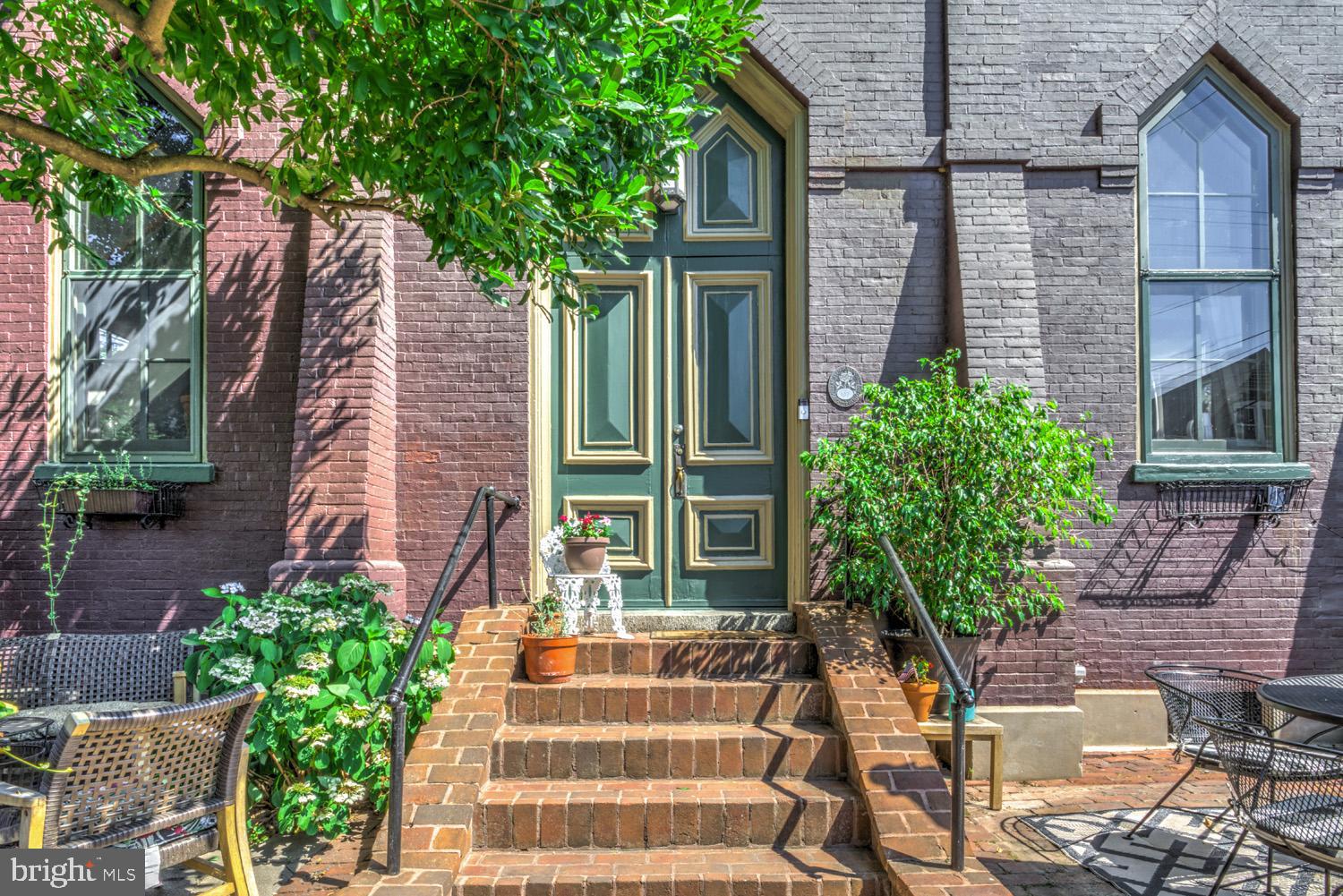 Truly a one-of-a-kind home in the heart of Marietta. This two-story loft condo conversion exudes charm with plenty of architectural features from yesteryear. The impressive wrought iron gate welcomes you into a private courtyard entrance, perfect for enjoying an early morning coffee or whiling away a lazy afternoon. The vestibule foyer has a trinity of doors leading into different areas in of the first floor in which one can admire the majestic great room with soaring cathedral ceilings and a gas fireplace. Off to one side is the dining room and in the opposite corner the first floor bedroom with ensuite full bath. Views from the second floor are just as dramatic and can be appreciated from almost any location, including the niche opening in the 2nd bedroom (also with ensuite full bath). The galley kitchen is open and airy with a cutout over the double basin sink looking down onto the first floor. Granite countertops, high-end blonde cabinetry and the subway tile backsplash add some contemporary flair. The full suite of appliances are included as is the stackable washer/dryer located just past the kitchen. Behind the second floor dining area is the access to the bell tower which is easily one of the standout features of this home. It’s a guaranteed attraction and talking point for any visitor and provides a peaceful and unmatched bird’s eye view of the surrounding town. The large side windows and skylights keep the home bright while the central air and gas furnace keep the home comfortable all year round. The condo ownership and extremely low monthly fee ($30) allows for one car off-street parking in the back and access to the shared basement. The town itself is unlike any other, and the residents pride themselves on the unique riverfront experience while enjoying the variety of restaurants, bars, local shops as well as nearby hiking/biking/water recreation. It’s located in the highly rated Donegal school district and has easy access to Rt 30 for longer commuting needs. If you’re looking for a home that stands out from any other and at a price that won’t break your budget…this is the one.