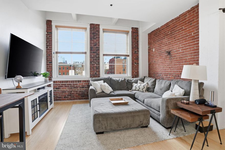 Welcome to Unit 317 at Bridgeview Place Condominiums in the heart of Old City. This beautifully updated 2-bedroom, 2-bath residence offers a highly sought-after floor plan, rarely available in this condition. The home blends historic character with modern comfort, showcasing exposed brick and expansive ceilings that enhance the sense of space and light throughout. Oversized windows offer stunning skyline views from every room, creating a bright and airy atmosphere. The thoughtfully upgraded kitchen features breakfast bar seating and opens to a spacious living and dining area. The primary bedroom boasts a walk-in closet customized by Closet Works and a private bath, while a second full bathroom and in-unit washer and dryer add convenience and functionality. A dedicated parking space and storage unit are also included—an exceptional value in Old City. Residents enjoy outstanding amenities, including a breathtaking rooftop deck with panoramic city views and a serene courtyard that serves as a quiet urban retreat.  The building offers secure fob access for both entry and parking, along with a 24-hour front desk.  All of this in a prime Old City location, just steps from some of Philadelphia’s best dining, shopping, and historic landmarks.