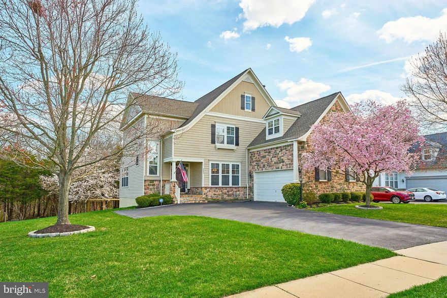 Welcome to your dream home in the highly sought-after community of Victory Lakes! Nestled among a lush tree-lined backdrop, this stunning single-family residence offers the perfect blend of luxury, comfort, and convenience.

Situated upon a meticulously landscaped, level lot, this residence spans over 4700 square feet of flawlessly crafted living space, including an expansive walk-out basement opening onto a large paver patio adorned with a charming firepit, where cherished moments with friends and loved ones await.

Crossing the threshold, you'll be greeted by a wealth of upscale features, including gorgeous plantation shutters, gleaming hardwood floors, deep crown moldings, and recessed lighting throughout.  The seamless flow of the open floorplan effortlessly guides you through distinct formal living and dining areas, while a discreet, secluded office offers a sanctuary for productivity or relaxation.

Or indulge your culinary passions in the incredible gourmet kitchen, featuring a colossal center island that commands attention amidst granite countertops, double ovens, gas cooktop, and abundant cabinetry, seamlessly merging with the airy breakfast space that spills onto a covered screened-in porch. Meanwhile, the inviting oversized, light-filled family room captivates with its gas fireplace and panoramic views of the serene backyard.

Ascend to the upper level, where the expansive primary suite reigns supreme with a private sitting room stretching out over the garage.  Two lavish walk-in closets and an ensuite bath complete with a  corner soaking tub, walk-in shower, and double sink vanity make this primary suite the ultimate escape. 
Three additional sunlit bedrooms, an additional hall bath, and a conveniently located laundry room complete this level, ensuring effortless everyday living.

Descend to the lower level, a haven for entertainment aficionados, where you will find a well-appointed wet bar surrounded by ample space for hosting gatherings, a comfortably sized bedroom, full bath, and an additional storage room. Step outside to the enchanting paver patio, where the crackling firepit sets the stage for al fresco revelry under the stars. 

Residents of Victory Lakes enjoy a wealth of community amenities, including basketball courts, bike trails, a clubhouse, pool, fitness center, tennis courts, playgrounds, and more. With its convenient location and easy access to DC and surrounding areas, this home offers the perfect combination of luxury living and suburban convenience. Don't miss your chance to make this exquisite property your own!