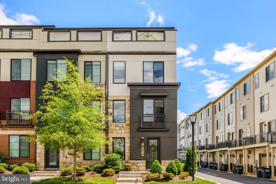 Welcome to 4819 Garden View Lane, a thoughtfully maintained 3-bedroom, 3.5-bath end-unit townhome with an oversized one-car garage, ideally positioned to enjoy abundant natural light. The versatile entry-level features a spacious recreation room currently outfitted as the home's welcome center, with locker-style storage and a desk. This level has many additional possibilities, including a perfect home office, fitness area, or casual living space.

The main level is the heart of the home, centered around a gourmet kitchen featuring stainless steel appliances, including a 6-burner cooktop, wall oven, and built-in microwave/convection oven combo. A large center island seats four comfortably, and a generous pantry provides excellent storage. Step out onto the balcony, ideal for grilling and outdoor dining.

Upstairs, the primary suite offers a walk-in shower, dual-sink vanity, and ample closet space. A second well-sized bedroom also includes an ensuite bath with a tub/shower combo. The washer and dryer are conveniently located on this level. The top floor features a third bedroom, a full bath with a walk-in shower, a cozy family room, and access to the rooftop terrace—perfect for relaxing or entertaining.

Hardwood floors extend throughout the home except for the upper-level third bedroom. Custom window treatments are installed throughout.  This home is perfection! There is nothing to do but move right in. 

Located near additional guest parking within The Preserve at Westfields, the community offers a pond, walking trails, a boardwalk, a tot lot, and an amphitheater. Enjoy unbeatable convenience with Dulles Airport less than 5 miles away, and shopping, dining, and major commuter routes (Route 28 and Route 66) all nearby.