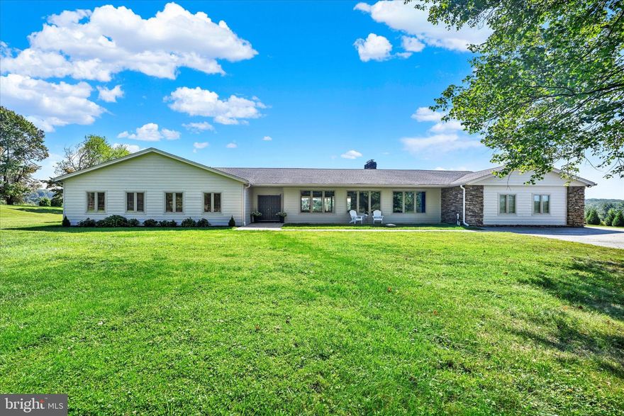 Prepare to be amazed!  This beautifully renovated mid-century modern Ranch Style home with nearly 5 acres, 4 bedrooms, 4 en-suite baths & a powder room, sits at the top of the hill and offers the most spectacular panoramic views of an expansive, level yard and beyond. This home offers unmatched tranquility, elegant design and spaces ready for sophisticated entertaining & comfortable living.  From the front to back double door entries, the vaulted, beamed ceilings bring drama & warmth to the living, family and dining room areas.  The walls of windows bring the outside in and frame the breathtaking vistas beyond.  Just incredible!  Beautiful wood floors elevate the entire main level.  The stacked stone wall for the gas fireplace brings texture and coziness to the dining and entertaining areas.  Step into the "heart of the home": the chef's kitchen.  With its neutral palette, soft close cabinetry & a beautiful 6 burner gas range, this stainless and granite eat-in kitchen certainly delivers.  There is a true entertaining island (9' x 4") with room for 4 comfortably.  The adjacent sunroom/solarium/breakfast room or den has 2 entrances to the rear patios with an abundance of natural light. Ideal for entertaining!  Walk thru the barn door to an upscale laundry room area with granite topped counter, soft close designer cabinetry, laundry sink, and washer and dryer. This area is complemented by a stylish powder room, a hallway with 3 spacious pantries & doors to the rear patio & to the lower-level.
The 4 bedrooms are located on the other wing of the home.  Each bedroom has a tastefully designed en-suite bathroom, giving every resident or guest a true retreat of their own.  The spacious Primary Suite faces that phenomenal rear view of the home and offers one of the most spectacular walk-in closets you will ever see.  With custom designed drawers, hanging rods and shelving, this closet is everyone's dream come true! (The rear section of this closet could also double as an office)!  The Primary en-Suite Bathroom has a luxurious feel with a double vanity, a gorgeous walk -in shower, a generously sized linen closet, a Sauna and views of the countryside.  The remaining 3 Bedrooms also with en-Suite bathrooms offer generous sizes and great closet space with racks, shelves and drawers, making the bedrooms versatile, for guests, or multigenerational living.  Pick one of these well-lit rooms for an office if that suits your needs!  Travel down to the Lower Level & see the well-lit finished space - perfect for a workout area, meditation space, or game room.  The covered rear patio with its wood paneled ceiling, 3 skylights & recessed lighting is simply divine and perfect for entertaining, reading or just relaxing.  The space has added potential for a full outdoor kitchen! The home also offers an oversized two car, side load garage and has the possibility of adding another garage. The property's acreage provides nearly endless opportunities for recreational activities.  Important System information: Well, Septic, Hot Water Heater replaced in 2016.
Trane Heat Pumps (4 ton & 4.5 ton) w/Propane Tank (owned) back-up heat. Home was renovated in 2019 to include, but not limited to: Roof, Windows, Appliances, Cabinetry, 2 Panel Doors & Hardware thru-out, Exterior Hardi-Plank siding, newly renovated Bathrooms, Hardwood Flooring, Tile Flooring, Lighting, Garage Door(2021) & more.
Current sellers have: Purchased & installed Solar Panels, added downspouts, installed extensive landscaping and added many "maintenance free" upgrades to make your living easy.  Set in sought-after Phoenix, the property feels like a private, countryside retreat yet is minutes from downtown Jacksonville, parks, trails, area shopping and dining. It is the perfect setting for those seeking tranquility without sacrificing convenience.  Your enclave awaits!  Make your appointment today!
