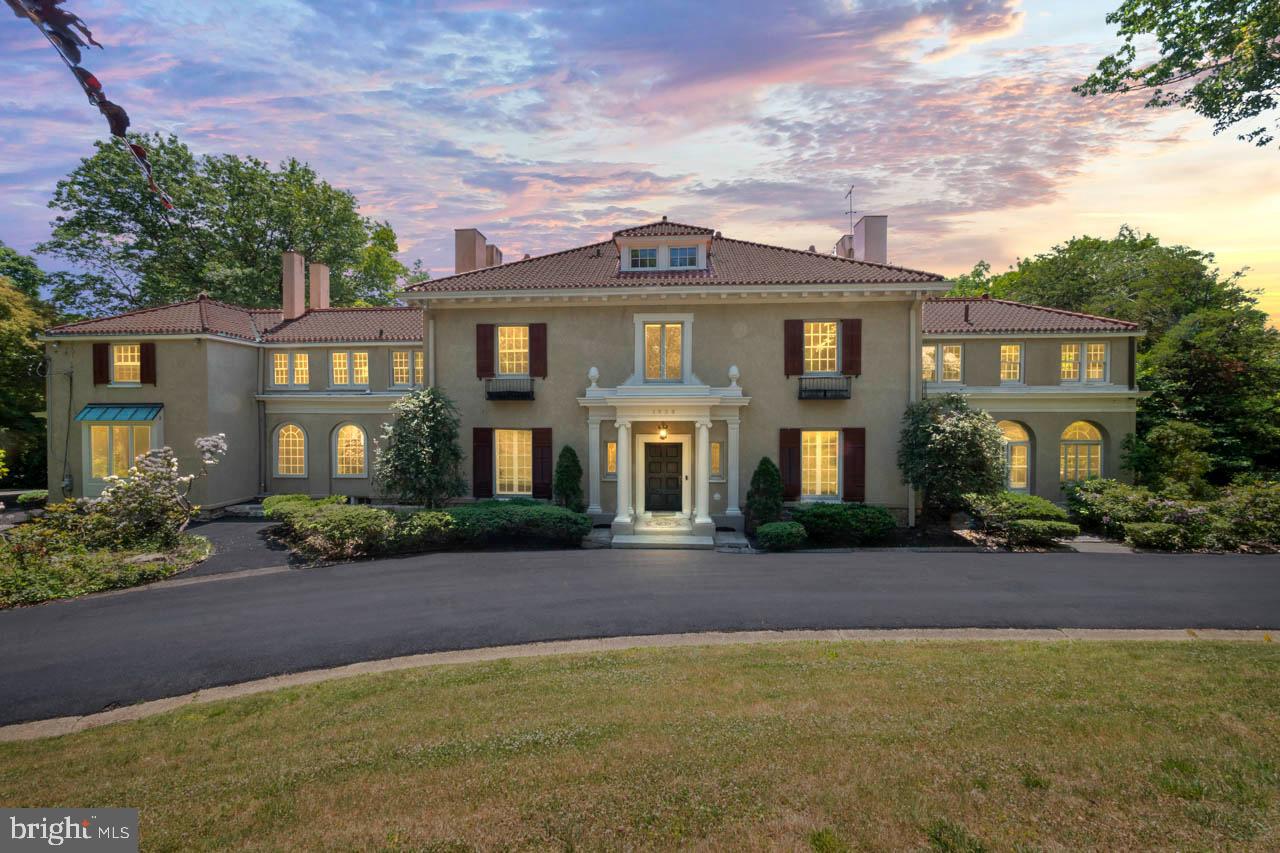 Welcome to 1539 Hampton Rd. This stunning historic Greek Revival Colonial, sited on almost two acres in the best neighborhood in Rydal. This home was the site for the Ogontz School for Girls with a guest house designed by famed architect Horace Traumbauer. Situated on a multi-terraced landscape with extraordinary mature trees and beautiful gardens, the house features seven rooms on the first floor for people to live a luxurious and civilized life. From the circular drive, step into the formal entry that runs front to back and leads, by French doors, to an expansive outdoor terrace, overlooking a fountain and pool. To the right of the foyer is the formal living room, with French doors, and fireplace. The welcoming sunroom, with fireplace and windows on three sides, is reached from the living room. The formal dining room with fireplace and floor-to-ceiling bay window sits to the left of the foyer. Beyond the dining room is the spacious kitchen with high-end appliances and beautiful arched windows. Beyond the kitchen is the casual family room which leads to a covered porch and to the garage-end of the driveway. Completing the first floor are two powder rooms (one at the front door and one off the family room), an office/den at the front of the house, an ample coat closet, and the start of the stunning turned staircase to the second floor. On the second floor, you will find a beautiful primary suite with an outfitted dressing room and a large bath with whirlpool tub and separate shower. There are four more bedrooms and three more bathrooms on the second floor, all are spacious and bright. There is also a screening room for movies and video games, and a laundry area conveniently located near the bedrooms. A door in the second floor landing leads to the third floor space that could serve a multitude of uses, from guest room, to office, to exercise space, or studio. Across the driveway from the first floor family room and covered porch is a four-car garage with attached living space .