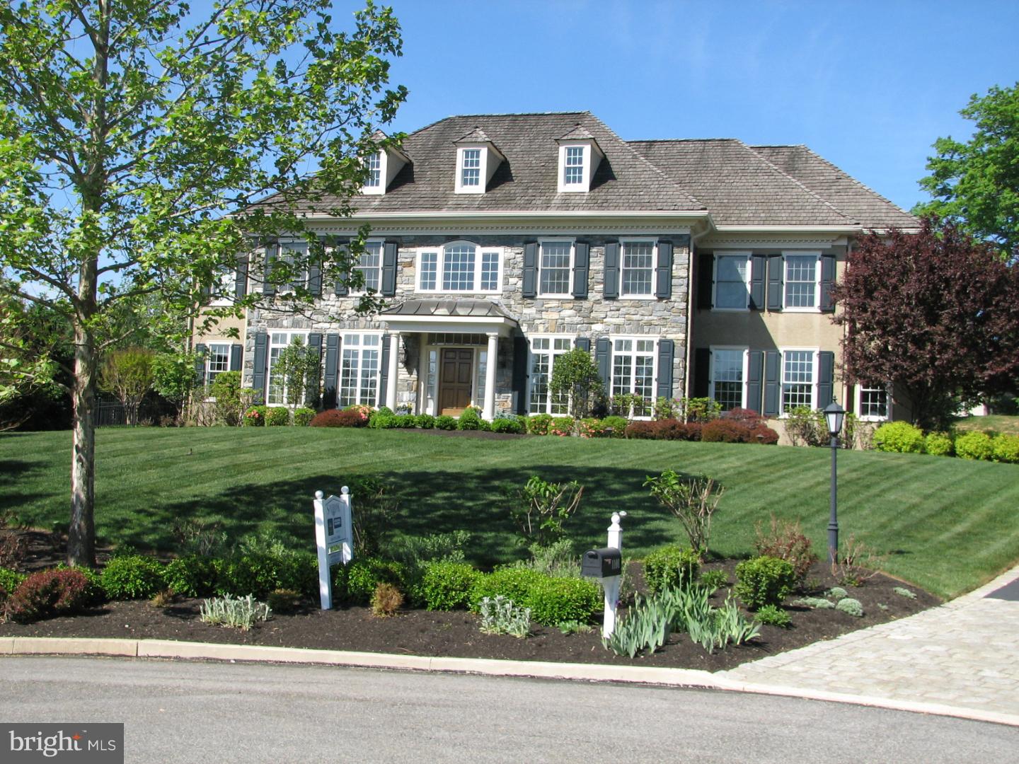 Taste & refinement coupled with convenience & seclusion are the cornerstone of Saybrook. No element was left to chance, courtesy of Bentley Builders and a detail oriented home owner. The stone front harks back to handcrafting of early Main Line days. Landscaped & hardscaped with slate walkways, an entertaining patio & a natural rock wall add to the ambiance of this purebred home. Step inside & revel in Classical architecture. A cherry wood library opens to an adjoining sun-filled reading nook. Your eyes will decide on the focal point in the family room either the 2 story floor to ceiling stone fireplace, the bank of windows or the view into a meticulously thought out kitchen. Prepare fine cuisine surrounded by granite counters, tumbled stone backsplash, 6 burner gas stove & seamless cabinet clad refrigerator, dishwasher & oven hood. The backstairs are so convenient. A Butler's pantry & 2 powder rooms complete the 1st floor. This floor plan is designed for entertaining. A separate Master Suite includes a spacious bathroom & haberdasher's closet. There are 4 additional bedrooms & 2 full baths. The precise planning continues on the lower level; room for billiards, movie viewing, exercise stations, an oenophile's climatized cellar & a powder room. Seller had a landscaping plan that reimagines the lot drawn up.