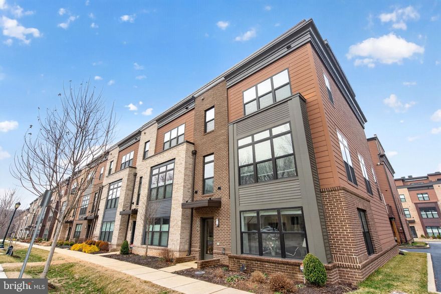 Welcome to Rockville’s sought-after Tower Oaks community! This beautifully designed modern townhome is the LARGEST of the models (DRAKE) with an-in home ELEVATOR! Stylish, low-maintenance living with a spacious open layout, contemporary finishes, and thoughtfully designed indoor-outdoor flow across four impressive levels. The entry level features a versatile and light-filled bedroom, office, or den with elegant French doors, a full bathroom, and access to the attached two-car garage. The main living level is designed for both comfort and entertaining, featuring expansive open-concept living and dining spaces, a beautifully appointed kitchen with quartz countertops, stainless steel appliances, abundant cabinetry, and a large center island. Enjoy a sunny breakfast area, a separate dining space, and easy access to a spacious balcony off the kitchen, perfect for morning coffee or dining al fresco. The living room is anchored by a cozy gas fireplace with TV setup. The third level offers a truly spacious primary suite with a large custom-organized walk-in closet and a luxurious en-suite bath. This floor also includes a second bedroom with en-suite bathroom as well as a conveniently located laundry room. The top level provides exceptional flexibility with a generous family room opening to a private rooftop terrace, offering the perfect setting for entertaining, lounging, or future customization with the potential for an indoor kitchenette or bar area. This level also includes an additional bedroom and full bathroom. Tower Oaks residents enjoy access to The CORE, an exceptional community amenity center featuring a pool, fitness center, yoga studio, club room, café, fire pits, sport court, green spaces, grilling stations, and gathering areas, bringing a true lifestyle component to everyday living. Ideally located near Clyde's Tower Oaks Lodge, Park Potomac, Pike & Rose, I-270, and major commuter routes, this home offers elevated living with exceptional convenience!