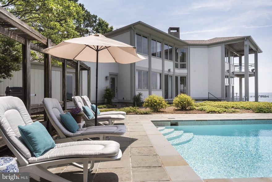 Stunning Waterside Retreat!Fred Fishback designed home impeccably built by Bert Winchester in sought after Watergate. Panoramic views of South River to the Bay from floor to ceiling windows. An entertainers dream, this open floor plan is perfect for wowing your guests indoors&out.Saltwater pool,upper lvl family rm/deck w/views,2 masters(1st flr)sleek modern kitchen. Great storage,2 car garage.