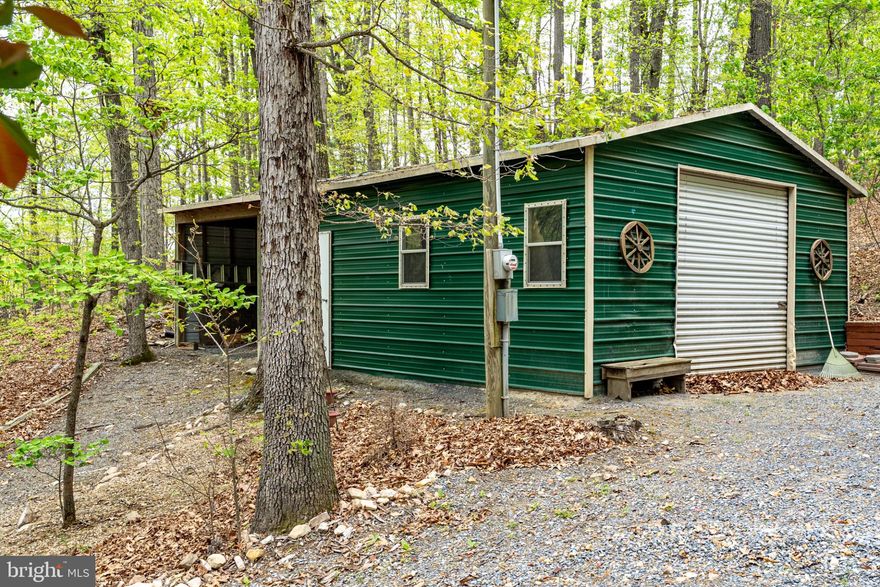 Listed just in time for hunting season. Wooded, buildable lot with garage and newly installed gravel entrance. Lot provides access to National Park and 410+ Acre reserve for hiking, hunting and recreational exploration. Come build your perfect getaway cabin or primary residence with the privacy of nature. This property also allows for access to Shenandoah River through community river lot. Electric is already ran to garage for easy hookup.