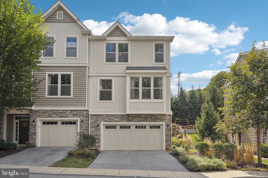 Welcome home to this stunning end-unit luxury townhome in the exclusive Paoli Walk Community. This  5-year young home was previously the model and comes with all the accoutrements one would expect.  Found in the highly desired Great Valley School District, this home features everything from a chef's kitchen to beautiful exterior hardscaping. As you approach, you will first notice the two-car garage.  Entering the home, you are greeted by hardwood floors and the first floor finished space which is perfect for a guest bedroom, home gym, office or playroom. Heading up the oak risers to the main living space, you will find an open floor plan with an elegant tiled gas fireplace in the bright great room. Adjacent is an eat-in kitchen with beautiful Quartz countertops, a tile backsplash, stainless steel appliances and gas cooking with an exterior vent range hood. The dining space is in the rear with a cool home office space nearby. A nice half bath finishes off this level. Ascend one more level past the massive mirrored accent wall, you will find the primary suite and two additional bedrooms. The primary is in the rear and features two closets and an ensuite featuring lovely cabinetry, a water closet and an oversized tiled shower with an embedded bench.  The location can't be beat with easy access to Routes 30 and 202 as well as I-76 for the commuter.  Valley Forge Park is nearby for some outdoor time in addition to loads of nearby shopping and activities. This one won't last long. Make your appointment today!