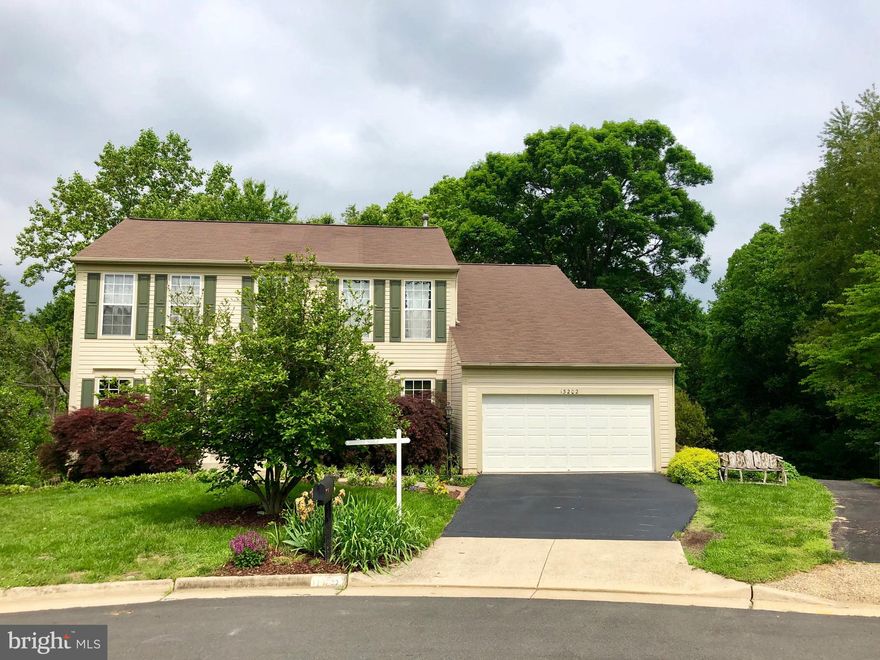 Gorgeous colonial home tucked on a quiet cudesac near commuter routes.  3 full levels of living space that includes an amazing and huge 980 sqft patio off the back of the house.  The patio boasts a built in fire pit and stairs have been added from the deck down to the patio.  Beautiful kitchen has been fully renovated to include new maple shaker style, soft close cabinetry, granite counters, tile backsplash, stainless appliances and premium tile flooring.   Upper level has 4 generous sized bedrooms with vaulted ceilings.  Hall bath has been updated and includes double vanity.  Master suite has a sitting room,  large bedroom with vaulted ceiling and fan/light, walk in closet and wonderfully renovated luxury master bathroom.   Master bath has stand alone soaking tub, large double shower, dual vanities, skylights and plenty of room.   The basement is fully finished with a 5th bedroom, laundry/storage room,  theatre/game room and open recreation space with a bar.   Basement has rough in for a full bathroom.  This house is fantastic for entertaining!  So much is new!  New paint and carpet throughout.  Home backs to stream, common area park, and community has great amenities including outdoor pool, club house, walking trails, basketball court, and open fields, and playgrounds.  Don't Miss!