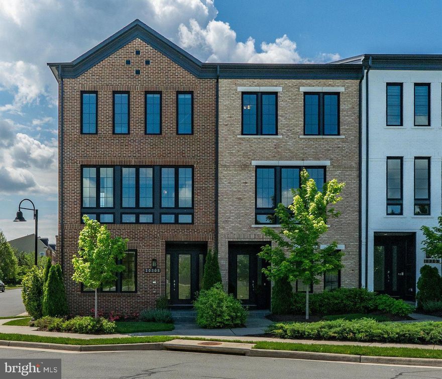 Discover refined living in this stunning end-unit townhome in West Village of One Loudoun! With over 3,000 square feet of sophisticated space and almost $100,000 in Miller & Smith builder upgrades,  this exceptional residence offers luxury, comfort, and convenience. Rich hardwood floors highlight the open-concept layout throughout the main living areas, a designer gas fireplace with an upgraded surround and custom mantel, and expansive windows that flood the home with natural light.

The chef’s kitchen is a showstopper, featuring sleek quartz countertops, an extended center island ideal for entertaining, stainless steel appliances, and upgraded cabinetry. Enjoy seamless indoor-outdoor living with a covered balcony perfect for morning coffee or evening relaxation.

Upstairs, the spacious owner’s suite offers a private retreat with a spa-inspired bath and walk-in closets, while the additional bedrooms provide versatility for family or guests' needs. The lower level offers a private fourth bedroom or home office space complete with a full bath, ideal for multigenerational living or overnight guests. A convenient 2-car garage and ample storage complete this impressive home.

All this, just steps from the heart of One Loudoun’s ever-growing town center—Ashburn’s premier destination for shopping, dining, and entertainment. Retail continues to thrive with the recent additions of flagship stores like Lululemon, Sephora, Warby Parker, and Madewell, joining longtime favorites such as Trader Joe’s, Barnes & Noble, and The Alamo Drafthouse Cinema. New dining hotspots and upscale coffee bars now sit alongside award-winning restaurants and lively nightlife venues, offering a true "live, work, play" experience.

One Loudoun’s downtown is also home to a vibrant calendar of annual events that bring the community together, including Taste of Loudoun, the Summer Concert Series, Winter Wonderland Tree Lighting, Halloween Spooktacular, and the Loudoun Arts Festival—just 5 minutes from your front door via  Central Park.

This townhome is ideally situated just across from the park, close enough to enjoy everything One Loudoun has to offer, yet tucked away in a quiet pocket that feels like a peaceful haven the moment you step inside. Whether you're catching a show, meeting friends for dinner, or strolling through tree-lined paths, you’re perfectly positioned to enjoy the energy of the town center—with the comfort and serenity of home just moments away.