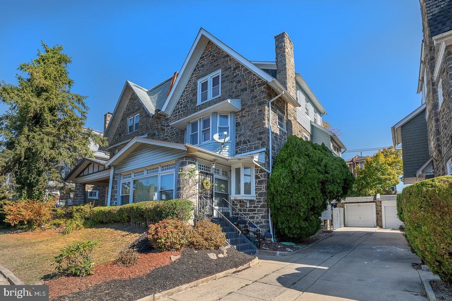 Grand 6 bedroom stone twin home with Garage, filled with architectural charm, is nestled in the heart of the lovely Overbrook neighborhood. Step into the spacious sun porch that leads to the sun filled and large living room with fireplace. The original French doors open to the spacious dining room. Fully equipped kitchen with breakfast room opens to the private rear yard and patio. The second floor houses 3  spacious & sunny bedrooms and a full bathroom as well as the third floor.  Large finished basement with powder room and plenty of storage space. Beautiful hardwood floors throughout. Conveniently located to public transportation and very close to Center City! Property being sold in its AS-IS condition. This lovely home does need updating, particularly the kitchen.  If buyer is choosing an FHA loan, buyer is responsible for any FHA repairs that may be required.