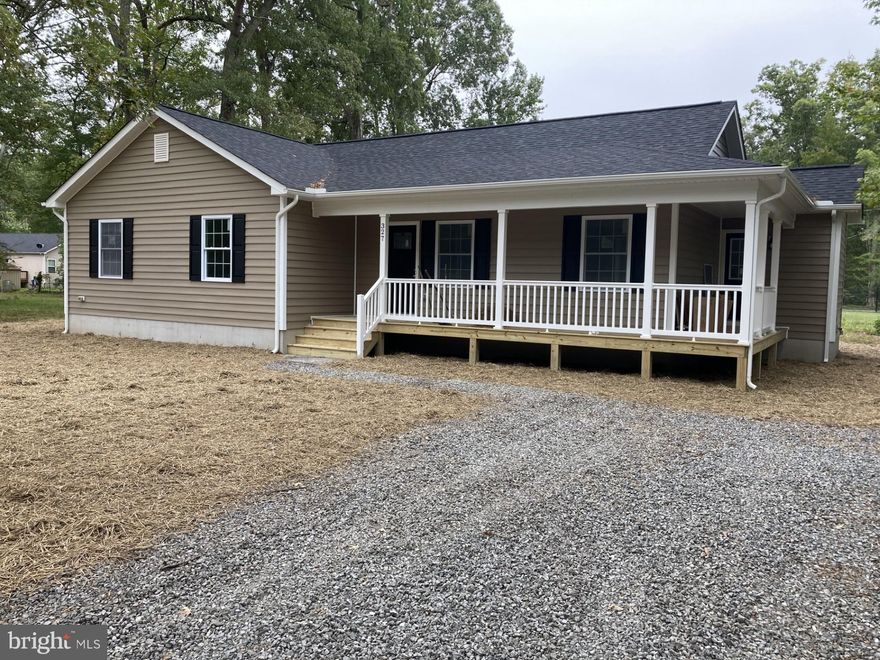 This home will be finished soon so get your offer in today!  Actual color of the home is Blue Gray. See the 2nd and 3rd picture.  1st picture of the kitchen is the correct kitchen with the vaulted ceiling.  Finished pictures show a similar home.  This charming 1,500 sq ft home is a hidden gem, offering a lifestyle of leisure and convenience. Nestled in a voluntary HOA community with private access to a beach, picnic area, boat ramp, slips, and dock.   This property boasts a myriad of features that are sure to capture your heart.  It has convenient public water and sewer. One level living is a breeze and The heart of this home is undoubtedly the spacious kitchen. A chef's dream come true, it showcases a generous island, extensive cabinets, and a convenient pantry. You'll have plenty of space to whip up culinary delights for friends and family. 
Say goodbye to clutter! This home comes equipped with linen, pantry, and coat closets, ensuring that everything has its place. And that's not all – you'll find closets galore throughout the house, including a luxurious his and her walk-in closet in the master bedroom. There are ceiling fans in all the bedrooms, ensuring a gentle breeze during warm summer nights.  
Step outside onto the 10x12 deck at the back of the house, where you can relax and savor your morning coffee or host gatherings with friends and family.  
Don't miss the opportunity to make this wonderful home yours. With its ideal location, abundant storage, and thoughtful features, it's ready to welcome you to a life of waterfront bliss.