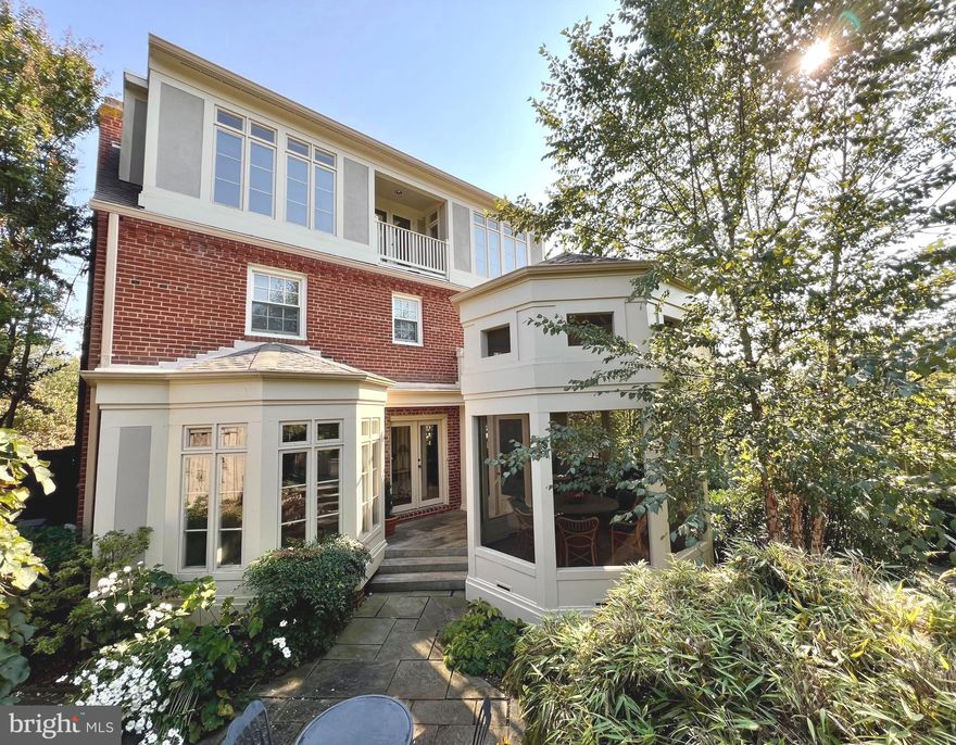 Not to be missed, this remarkable renovation and expansion by the renowned architect Richard Crone is an absolute showstopper! This four level brick beauty is filled with all of your favorite things and was featured on HGTV and various publications and programs as well as on a Silver Spring House Tour. Crone’s ingenious design relocated the main entrance of this magnificent home to Colesville Road Alley, which runs parallel to Colesville Road between Saint Andrews Way and Leighton. Opening the entry gate reveals the large jaw-dropping screened porch with a high-ceilinged octagonal dining area. The porch dining/sitting area is ideal for dining alfresco or relaxing while enjoying an evening or morning looking out at the beautiful formal gardens with a magnificent fieldstone patio. The beautifully landscaped and fenced Georgetown-like grounds were brilliantly designed by Lawrence V. Frank whose work is featured in the gorgeously illustrated book, Bold Romantic Gardens by James Van Sweden. So many outstanding features are found from the fourth level to the ground floor that it is difficult to list them all. The relaxing owner's retreat features French doors flanked by built in bookcases that lead to an adjoining open deck above the porch as well as a large, well-appointed walk-in closet.  A possible professional home office is ideal for busy households and the floor plan is very flexible and ideal for multi-generational living or an au-pair suite. The home is perfect for hosting large holiday dinners or fundraisers. This architectural wonder has fabulous elements of design with clever repeating patterns from the rooflines looking down from the aerie on the fourth floor to the light-filled breakfast room which mirrors the screen porch. No less than 11 built-in bookcases can be found sprinkled on throughout the house for the avid reader and bookworm. Cleverly placed skylights, a separate two car garage, driveway and alley parking, a highly functional gourmet kitchen, a stunning breakfast nook plus so much more! A whole house generator too for those stormy or snowy days.  Sligo Creek Park and the very popular Zinnias is just a short stroll from your door.  Walk to Metro and the future Purple Line... you simply cannot beat the convenience. Holy Cross Hospital is 0.9 miles and a 4 minute drive. This is truly a gem of a property that is filled with  sophisticated elements of design and function... and should not be missed. Lots of parking including an oversize detached 2 car garage and a driveway plus alley parking. Welcome home!