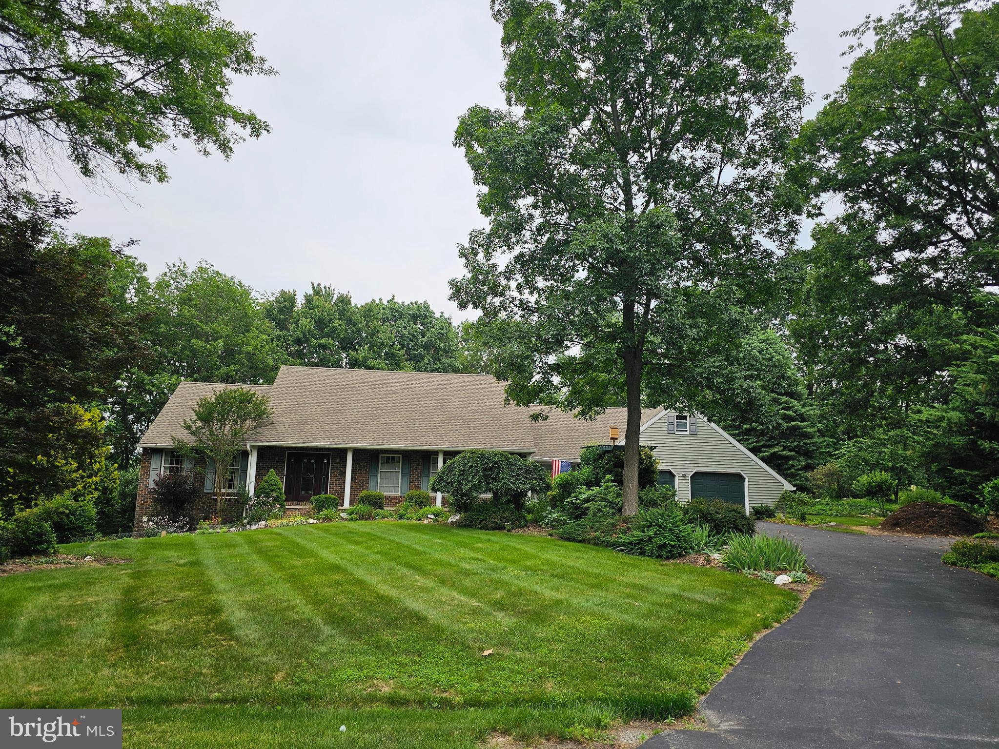 SPRAWLING Cape Cod style home with over 3600 above grade square footage situated on 1.49 acres at the end of a cul-de-sac. Surrounded by mature trees and extensive landscaping with a private rear yard that is adjacent to other wooded property. If you enjoy being outdoors and love nature in a peaceful setting, you will appreciate this home with a gorgeous sunroom, open deck, fenced rear yard, garden with watering system and paths around the property. The modern architectural style fully equipped expansive kitchen has two 9 ft granite counter islands, one with a vented down draft surface cooking unit and the other with under counter space for two wine/beverage centers as well as a bar sink. Enjoy warm, cozy evenings by the fire in the adjoining family room with a beautiful wood burning stone fireplace. 4 bedrooms and a full bathroom on the upper level. Generous closet sizes throughout the home. Oversized main level owners suite with dedicated office or nursery. OVERSIZED 28 x 28 two car garage with a full set of stairs to a 2nd floor storage room. Lower level is mostly finished with a full bathroom and second kitchen area. Roof was replaced about 5 years ago. FRESHLY PAINTED.