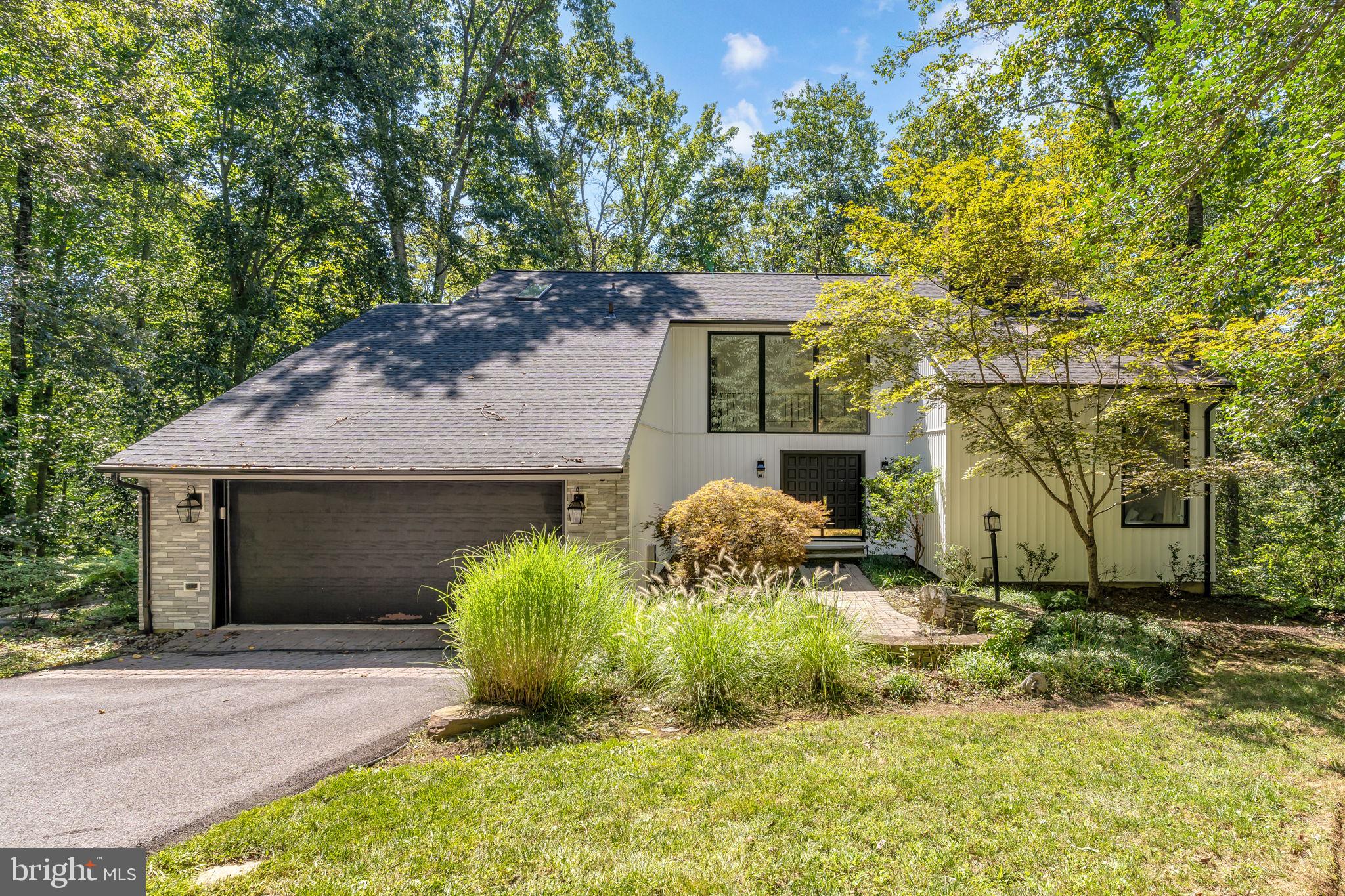 Nestled on a serene 1+ acre lot, this upscale contemporary offers the perfect blend of privacy, modern upgrades, and timeless design. A long, tree-lined driveway welcomes you into this quiet retreat, where expansive views can be enjoyed from the massive deck overlooking mature trees.
Inside, soaring ceilings and a striking stacked-stone two-sided fireplace anchor both the living and dining rooms. Recently refinished true hardwood flooring flows throughout the main level, complementing the upgraded light fixtures and fresh neutral paint. The kitchen shines with brand-new Quartz countertops, while the primary suite boasts a newly renovated shower. Brand-new carpet on the upper and lower levels adds to the home’s move-in ready appeal.
Recent Seller Updates & Features:
New siding and architectural shingle roof
Upgraded 1 full bath & 1 half bath
Newly refinished hardwood floors on the main level
Closed-in wall creating loft bedroom privacy
Fire-rated door addition
Updated mudroom with new washer/dryer (under 1 year old)
Brand-new garage door opener
Entire home eco-sealed for efficiency
UV light added to heating system for improved air quality & performance
Community & Location Highlights:
Located in the sought-after Huntington Woods neighborhood within the highly rated Crofton Schools district. Just minutes from shopping, groceries, and dining at Waugh Chapel, with easy access to Ft. Meade & NSA (25 mins), BWI Airport (30 mins), Annapolis (25 mins), and downtown Washington DC (45 mins).
This home offers the best of both worlds: a peaceful, private setting with convenience to everything the region has to offer.
