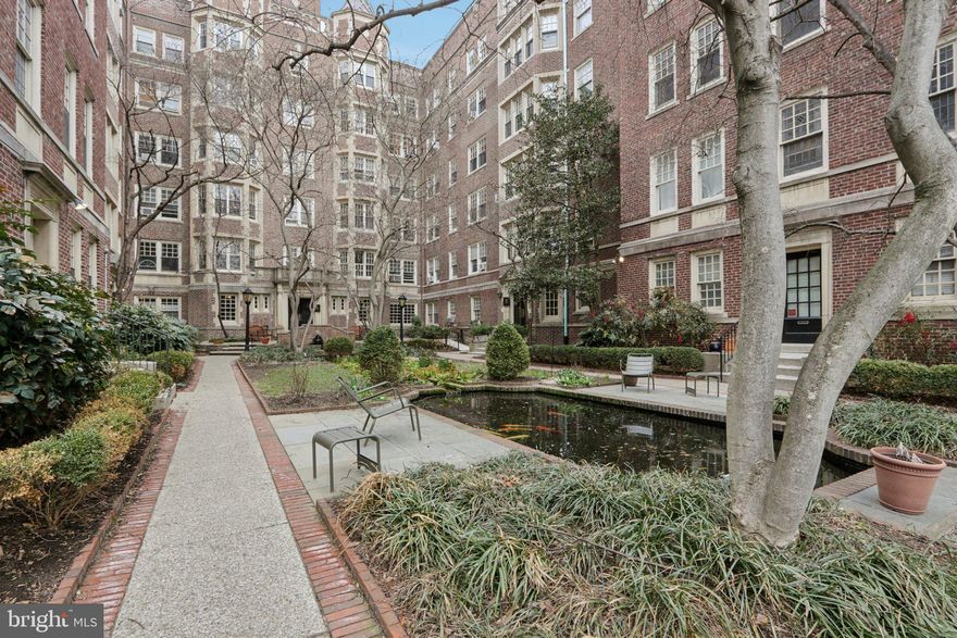 In the heart of West Philly's University City, this upgraded and beautifully maintained 4th floor, 917 sf condominium features a recently rehabbed kitchen with a gas range - a true chef’s preferred cooking method, unavailable in many of the other units at Garden Court.   There’s a large dining area, a spacious, bright living room and a classic bath with a combo washer/dryer. The current owner split the bedroom into two sections: one just for sleeping and the other as a dressing room/ office, for maximum work-from-home privacy.  A future owner can easily remove the inner walls without damage to the handsome oak floors if they prefer to have one large bedroom again.
     Garden Court was designed by West Philadelphia developer Clarence Siegel in the 1920s  in the gracious “pre-war” style which includes oversized windows, classic woodwork and hardwood flooring. Its timeless bathrooms feature leaded glass windows, ceramic tile floors and Vitrolite glass walls. The Preservation Alliance now holds a façade easement on its historic exterior. When it was built, the complex was offered as a 6-story luxury apartment development for residents who didn’t want the hassle of taking care of a house. Converted to condos in 1994, it still fills that hassle-free housing spot today.  Condo amenities include a glamorous indoor year-round swimming pool, exercise room, library, meeting room, indoor bike storage, and outdoor space with gardens, fountains and koi ponds in two gated courtyards.  The location is just six blocks west of the University of Pennsylvania and close to public transportation, nearby restaurants and coffee shops.