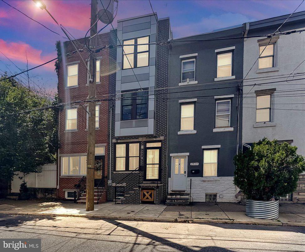 Move right in to this rarely available 3 Bedroom / 3 Bathroom townhome in TURN-KEY MOVE-IN CONDITION featuring better-than-new Contemporary Interiors, DEDICATED PARKING (the back alley or the rear yard/patio has a gate that could allow for one car parking) -- or play/ entertaining space, an INCREDIBLE ROOFTOP DECK w/ DRAMATIC PANORAMIC CITY SKYLINE VIEWS and 2 years of remaining tax abatement in FISHTOWN! Built in 2017, this 2,017-square-foot home welcomes you inside with tall ceilings dotted by recessed lighting, gorgeous hardwood floors, lovely millwork, and bright windows trimmed with custom blinds and shutters. Relax and entertain in the spacious living room and dining area flanked by tall wainscoting and the gorgeous open staircase. Ahead, the gourmet kitchen impresses with custom wood cabinetry, granite countertops, tile backsplash, center island, and stylish pendants. The stainless steel appliances include a gas range, side-by-side refrigerator, dishwasher and built-in microwave. Outside, the fully fenced patio is perfect for al fresco dining or parking, with access from Freedly Street. Head downstairs to explore the fully finished, windowed basement level, where you'll find a rec room area perfect for a family room, home office, gym or all of the above. Generous storage and a full bathroom with a walk-in shower add wonderful convenience to this floor. On the second floor, two spacious and bright secondary bedrooms share a well-appointed hall bathroom with a large tub/shower and contemporary fixtures. The top level is dedicated to your full-floor owner’s retreat featuring a king-sized bedroom topped with a stunning tray ceiling. Start and end each day at the built-in wet bar/coffee bar outfitted with a sink and beverage center. Great closet space and a designer bathroom with a double vanity and walk-in shower for two complete the level. Above, discover the home’s crowning glory — a remarkable rooftop with unimpeded views that skim across the entire city. This move-in ready home’s extensive upgrades include fresh paint, integrated speakers, ceiling fans, Nest thermostats, a Ring doorbell, pre wiring for smart home integration, and new HVAC with 10 year warranty+++. This tree-lined Fishtown block is surrounded by neighborhood parks and outdoor space, with Center City attractions and cultural institutions just minutes away. Enjoy immediate access to fantastic local fitness, shopping, dining and nightlife venues, including Meetinghouse, Circles and Squares, and Green Eggs Café. Abundant. transportation options — including the L bus service and I-95 put the rest of the city within easy reach. This turn-key move-in ready PRISTINE TOWNHOME is one not to be missed -- DO NOT WAIT!!!