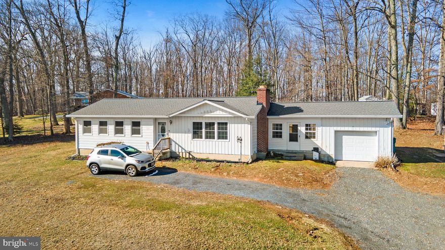 Welcome to 1970 Carrollton Road, Finksburg MD 21048! This charming rancher, meticulously cared for by its original owners, showcases 4 bedrooms and 3 full bathrooms with original hardwood floors throughout the main level. Noteworthy enhancements include a new roof in 2019, hot water heater in 2020, and all new windows & exterior doors in 2023. The kitchen received a facelift in 2009, while the primary bathroom was tastefully modernized. A wood-burning fireplace in the living room creates a cozy ambiance, and the basement pellet stove conveys. The basement also features a convenient kitchenette, one bedroom, and full bathroom. The enclosed breezeway, added in 2010, enhances the living space and provides a great entertaining area with access to the backyard patio. Nestled on 3+ partially wooded acres, this private haven offers tranquility and natural beauty. A one-car attached garage completes the picture of a home that has been cherished for generations. Don't miss the chance to make this your own!