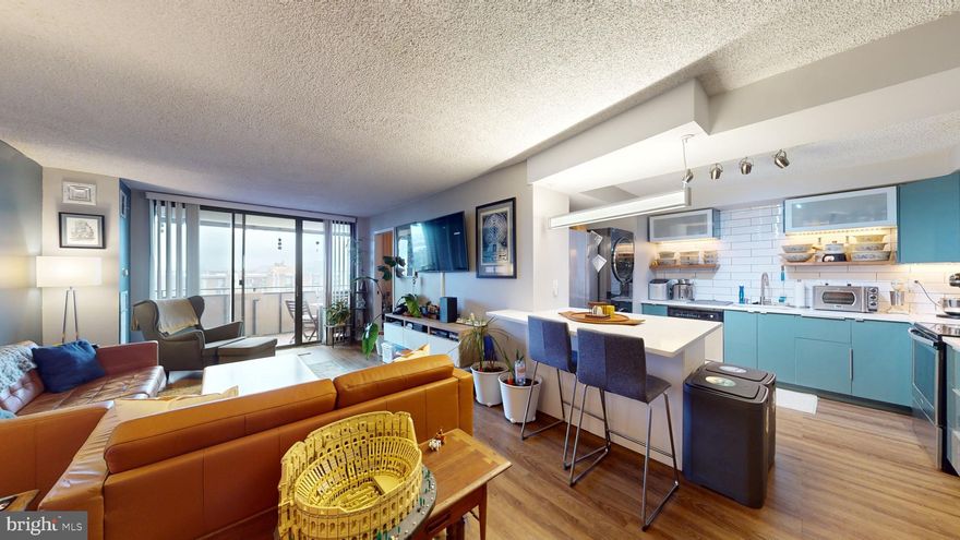 Welcome to the Templeton! Beautifully updated and modern 2 bedroom condo stands out from most others in its building. With wood floors and open living-kitchen concept, you have great space to cook, entertain and relax. Updated kitchen, countertops and very sleek washer/dryer in unit. Primary master bedroom has ample space and wall to wall closets for all your clothing and storage needs. Secondary bedroom is great flex space for either guest bedroom, home-office or any other need that you can imagine. Large oversized balcony provides great natural light and gives great  views of the metropolitan region. Building has great amenities to include a pool, outdoor basketball/tennis/pickleball court, open picnic and entertaining area, play gym, fitness center, basement storage, open, gated and underground garage plus much more. Pet friendly and very centrally located to stores, restaurants and the new future Landmark mall redevelopment.