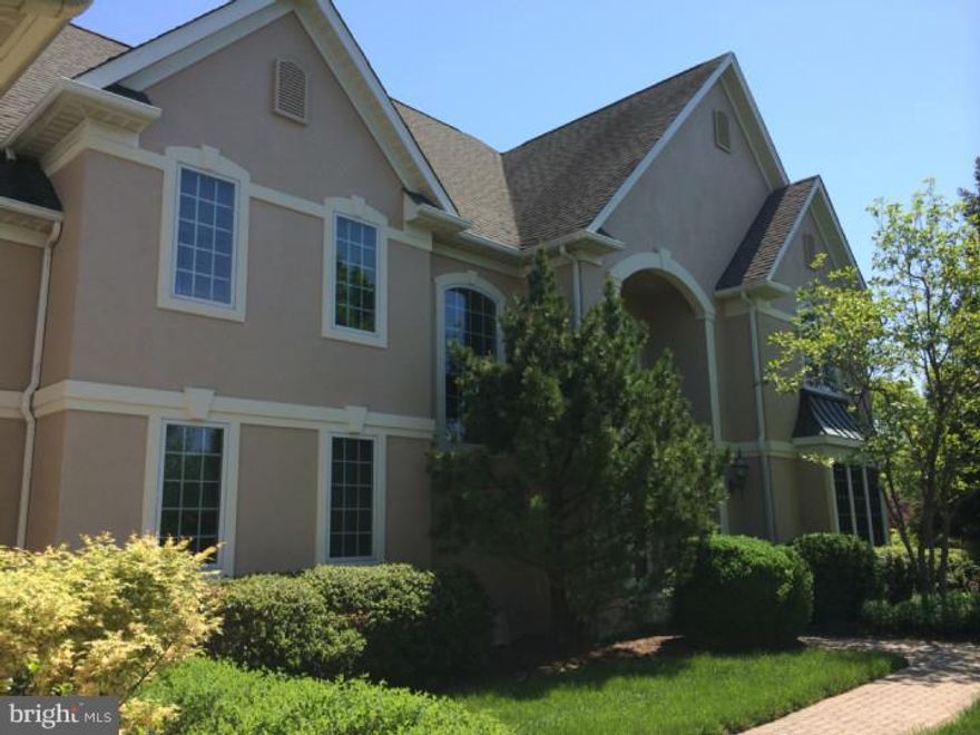 Stunning French Manor home crafted by Richard Zaveta  & situated on one of the best lots in the estate community of Springfield. Enter into the grand two story foyer and formal library/study adorned by Cherry bookshelves and arched built ins. Light-filled living and dining rooms flow together, separated only by fluted columns. Additional architectural details include extensive moldings, chair rail, wainscoting and crown. The large custom gourmet kitchen is a cook's dream with  butler's pantry and walk in pantry features granite countertops, tumbled marble backsplash, tile floors, Cherry cabinetry and high end appliances. Entertain in the sun-drenched 2-story Family Room with wood-burning stone fireplace w/gas starter. Retreat to the beautiful master suite, luxurious marble bath, sitting room and spacious walk-in closet. Four additional bedrooms and 3 full baths. Finished walkout lower level is a complete in law/nanny suite. Tiered patios.