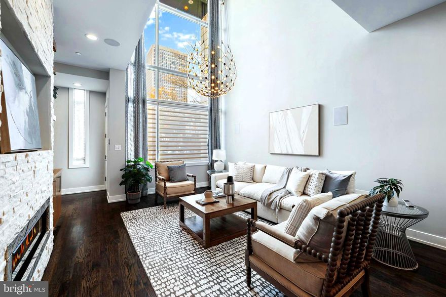 Located in the  heart of Society Hill, welcome to The Estates on 3rd Street. 214 S 3rd Street showcases as the original model unit of these renowned estates that offers a  distinct architectural design. Built in 2018, this property is truly the epitome of luxury and elegance.
The grand entrance, is one of the many  extraordinary features of the house. The expansive layout spans 4,583 square feet and boasts impressive 20-foot ceilings, allowing for an abundance of natural light to fill the space through the tall windows.

The first floor  is truly impressive, featuring a spacious living area . The exposed brick wall, adorned with wood cabinetry and floating shelves, creates a stunning visual centerpiece. You'll also find a built-in speaker system and a gas fireplace, adding to the overall ambiance of the room.

The living area seamlessly transitions into the dining area, which easily accommodates a large dining table. The gourmet chef's kitchen is a true masterpiece, equipped with top-of-the-line Sub Zero appliances, stone counter-tops, a custom back-splash, and meticulously crafted cabinetry. Additionally, a powder room is conveniently located on this level, and direct access to the  key code gated parking area at the rear .

Moving up to the second level, is the extraordinary primary suite  of luxury living. The elevated ceilings create an atmosphere of grandeur, while the suite offers two separate enter-in closets, a built-in wet bar, and a  deck. The primary bathroom is flawlessly designed, featuring a translucent glass shower, a freestanding bathtub, controllable heated floors, and a custom-designed vanity with a wardrobe-style layout, two sinks, and large mirrors.

The third level  consists of two generously sized bedrooms, each with its own full bathroom, enter-in closets, built-in shelving, and large windows that allow for ample natural light. Additionally, there is a convenient laundry room on this level, complete with an extended counter top, a sink, and attached cabinets for added storage.

The fourth level  is equally impressive, offering additional amenities . Here, you'll find a full wet bar, a sitting nook or office area, and access to the attached outdoor deck located at the rear . On the opposite side of the fourth level, there is a sizable bedroom with a full bathroom and an open-sized closet, making it ideal.

Luxury living extends to the finished basement, which can be  accessed via the full-stop elevator. This space features a media room, a wet bar, a powder room, and ample storage space . The media room opens up to a gym equipped with two enter-in closets . The house is also equipped with various smart tech features, including a key-pad security system and an installed video intercom system for convenience. Tax Abatement!

 Experience firsthand the meticulous craftsmanship and attention to detail that has gone into creating this exceptional property.