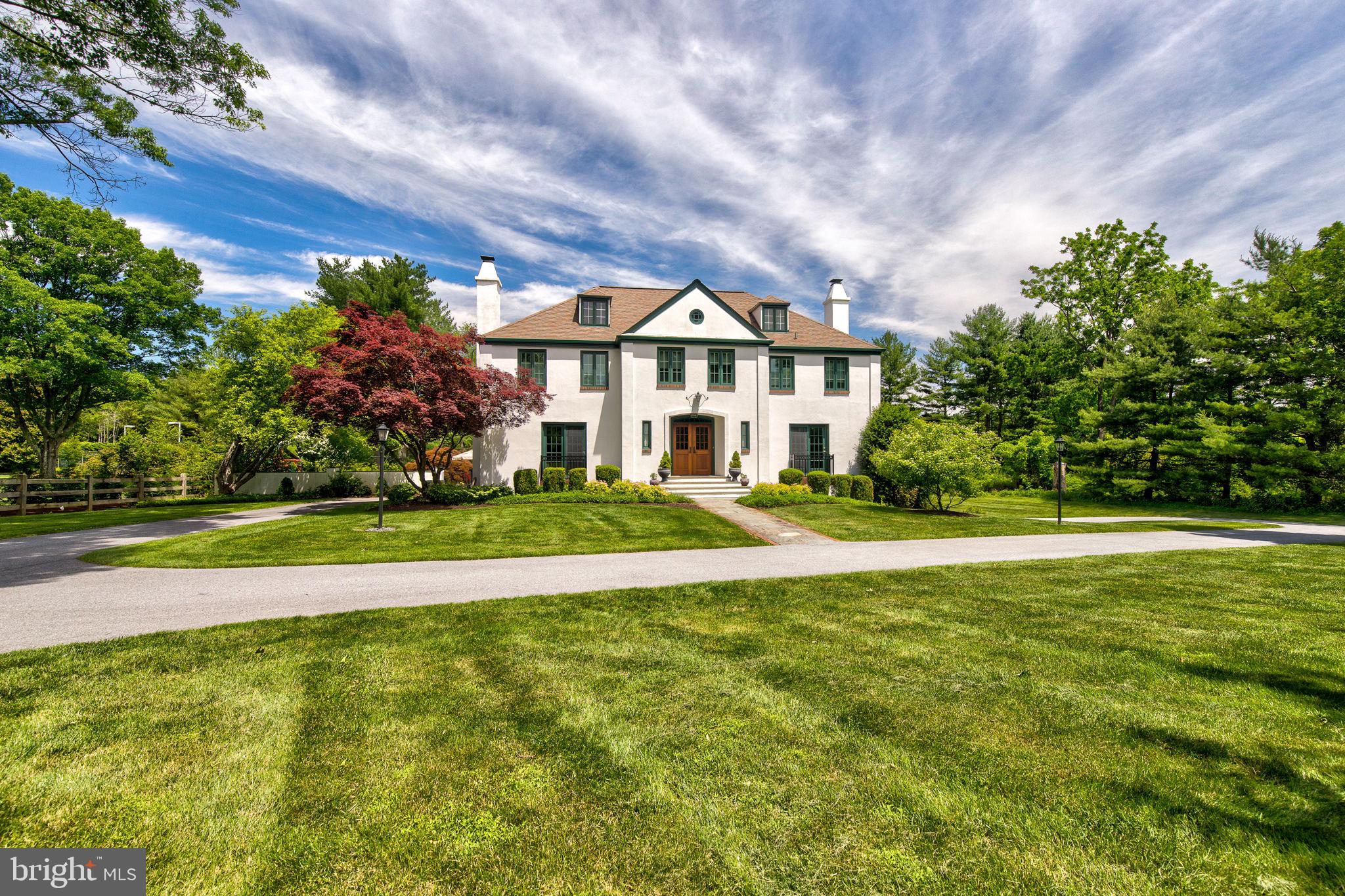 Don’t miss this RARE opportunity! You’ll love the sweeping TWO + acre grounds of this distinctive 4-5 BD, 4/1 BA classic French country house in a coveted estate neighborhood in Berwyn. It offers a private oasis that is bordered on one side by wooded open space and is located at the end of a no drive-through street. Enjoy your very own Augusta National-replica putting green (complete with bunkers) where golf enthusiasts can practice their short game! A beautiful flagstone terrace surrounds the sparkling pool, and the expansive lawn offers ample room for recreation and gardening. New mahogany front doors lead to a Entrance Foyer, which opens to a formal Dining Room with built-display cabinets and a large, gracious formal Living Room, with more built-ins and a wood-burning fireplace. Solid oak floors flow throughout and lead to the rear of the home, which offers an open-concept floor plan ideal for everyday casual living. The spacious Kitchen features a large island with breakfast bar seating, solid cherry cabinets, and granite counters. Gourmet appliances include a Viking gas range and exhaust hood, Décor convection wall oven, stainless SubZero refrigerator, and stainless Bosch dishwasher. The large Breakfast Area has more built-in storage and is open to the vaulted Family Room with gas fireplace. Glass doors lead to a flagstone patio, ideal for outdoor dining with views of the pool and yard. There is also a very private 1st floor Office/In-Law suite with an attached full 4th BA. Multiple closets and a powder room complete the 1st floor. A distinctive curved staircase leads to the 2nd floor. The Primary Bedroom suite was extensively renovated to create a luxurious BA with double vanity, oversized walk-in shower, loads of cabinet space, and a private water closet. The exceptionally large Primary Bedroom Closet is outfitted with custom closet organizers. Three more Hall Bedrooms share two more Full Baths, one with a shower stall and the other with a bathtub. The spacious 2nd fl. Laundry Room has built-in cabinets. A walk-up Attic provides flexible space which could be finished with add’l bedroom space if desired. The oversized 2-car Garage offers extensive storage as well. Downstairs, a walk-out, daylight Lower Level features a spacious Rec Room with built-ins and Bar, plus two more Bonus Rooms which are ideal for exercise, office, playroom, etc. This sturdy, stucco-over-masonry home has been meticulously updated over the years, with approx. $260,000 in improvements incl. roof, gutters, HVAC, windows, appliances, whole house generator, and much more. This scenic neighborhood is an enclave with wide, no-through-traffic streets, ideal for walking and cycling. This home is centrally located in highly ranked Tredyffrin-Easttown School District, just a short drive from parks, an abundant number of private schools, Upper Main Line YMCA, clubs, shopping, and restaurants. Nearby Paoli Train Station offers express Amtrak service to NYC and other destinations. Tranquil location that is also within easy commuting distance to Center City Philadelphia, the Airport, and corporate centers. Contact your agent or click on the virtual tour link to view walk-through video, 3D Matterport Tour, floor plans, and more!