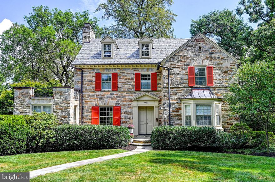 Welcome to 5507 Saint Albans Way, a classic stone colonial situated on a level, beautifully landscaped corner lot in the desirable neighborhood of Homeland. This stately property offers an impressive five plus bedrooms, three full and two half bathrooms, and an array of architectural and luxurious features that will exceed all your expectations. Upon entering, you will be greeted by a double foyer entrance that leads to the sleek and sophisticated lacquered living room with wood-burning fireplace, built-in bookcases with up-lighting and a wonderful bay window. The sun-filled attached sunroom is perfectly cozy and equipped for family game nights, movies and relaxation. The heart of the home is the gourmet chef’s kitchen with a large center island, top-of-the-line stainless steel appliances, granite countertops, custom wooden cabinets and wet bar. This culinary haven offers ample space for prepping meals meanwhile entertaining guests in the decorative open dining room. Escape to the newly designed and renovated primary suite that features an impressive walk-in closet and a gorgeous and luxurious full bathroom with double sinks and "spa" walk-in shower while stepping outside to a private balcony for added pleasure. The remaining bedrooms are generously proportioned and offer much comfort and versatility. Don't miss the unique second floor immense family  room with a barrel ceiling, rows of built-in bookcases, wood-burning fireplace and a juliet balcony which is an added bonus. Lower level offers a recreation room with additional exercise space, laundry, storage and half bath taking advantage of all the utilized spaces. The stone-walled mudroom hallway is perfect for outside access and flow. Attached two-car garage with private driveway and two-sided and backyard spaces for outside enjoyment. Stone patio perfect for alfresco dining and entertaining. Conveniently located, close to all amenities, schools, and highways with easy commute to all. Special Homeland property!
