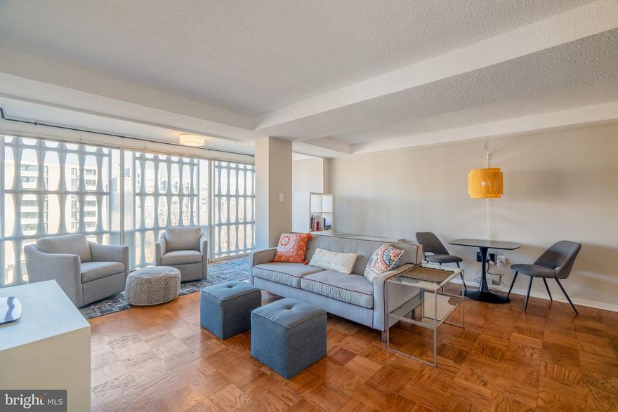 Bright and thoughtfully updated, this two-bedroom, one-bath corner unit with monument views sits in a secure, gated community conveniently positioned between the Wharf and Navy Yard.

An updated kitchen welcomes you as you enter, featuring a modern backsplash, stainless steel appliances, ample cabinet space, and under-cabinet lighting. Need storage space? The entry features a coat closet plus an additional built-in wardrobe. The living area is generously sized and works just as well for entertaining as it does for a quiet night in. Plus, the enclosed balcony has been finished and adds functional living space- creating a great spot for a home office, reading nook, or just a little extra breathing room. 

The primary bedroom offers plenty of space along with excellent storage. In the second bedroom, a Murphy bed makes for a perfect place for guests, a flexible work-from-home setup, or simply a second bedroom. To top it off, the bathroom has been renovated to add extra storage and modern touches. 

With northern and western exposures, this home feels open and airy the moment you walk, offering exceptional sunsets in addition to those monument views. The building itself offers great amenities with a pool, grill and picnic areas, well-equipped fitness center, concierge, and secure entry. Laundry is conveniently located in the basement, and extra storage is available. Add in easy access to Metro, the Wharf, Navy Yard, and all the dining, shopping, and waterfront energy in between, and you’ve got a home that is both practical and enjoyable to live in.